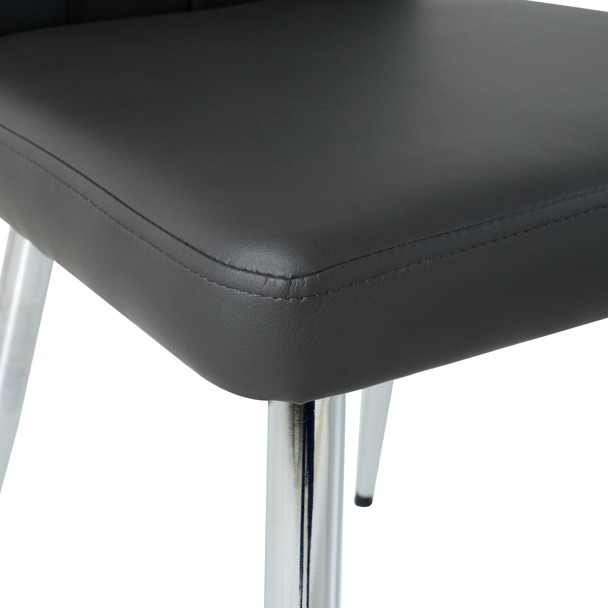 Closeup of black faux leather chair seat with stitched seams