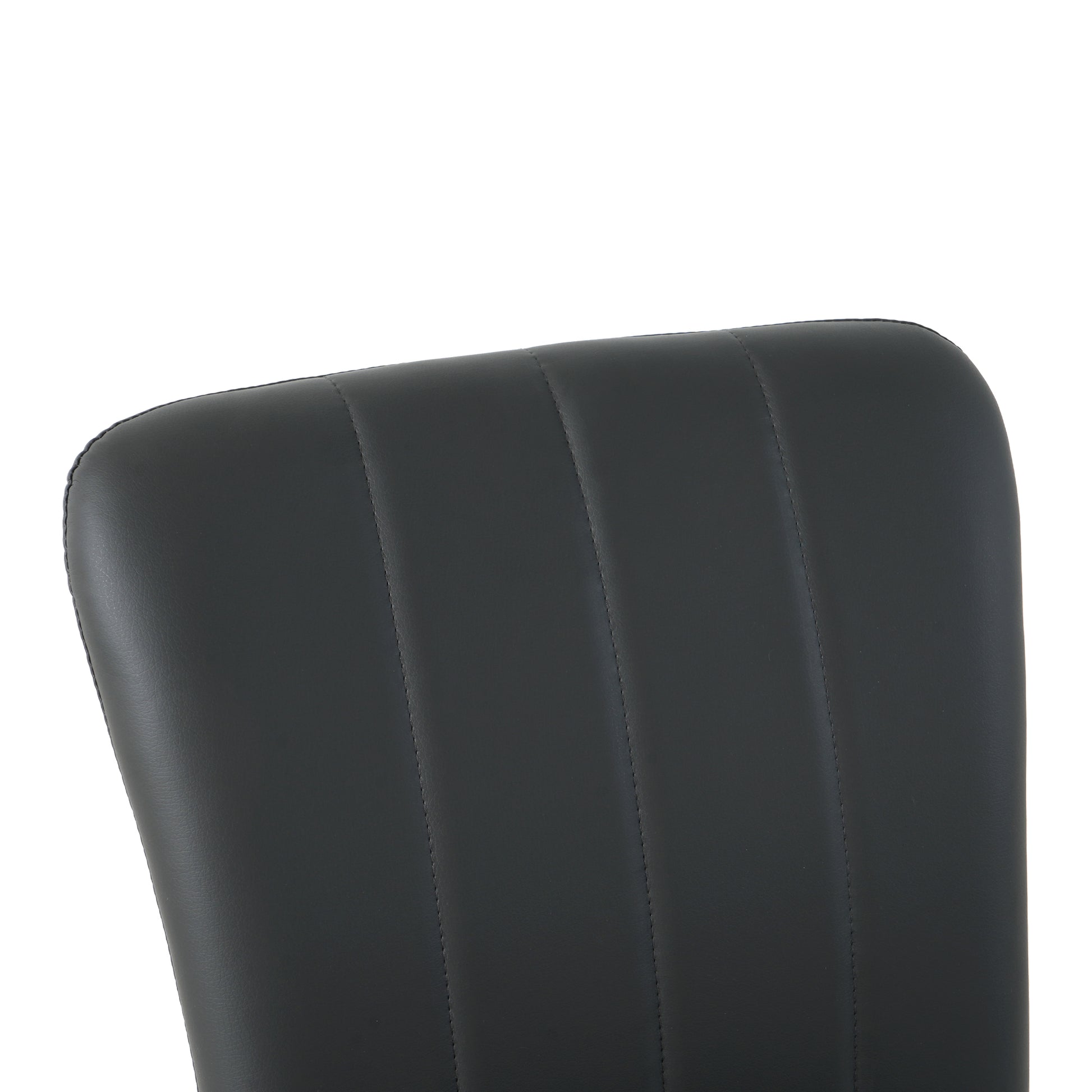 Closeup of black faux leather chair back with vertical channel tufting