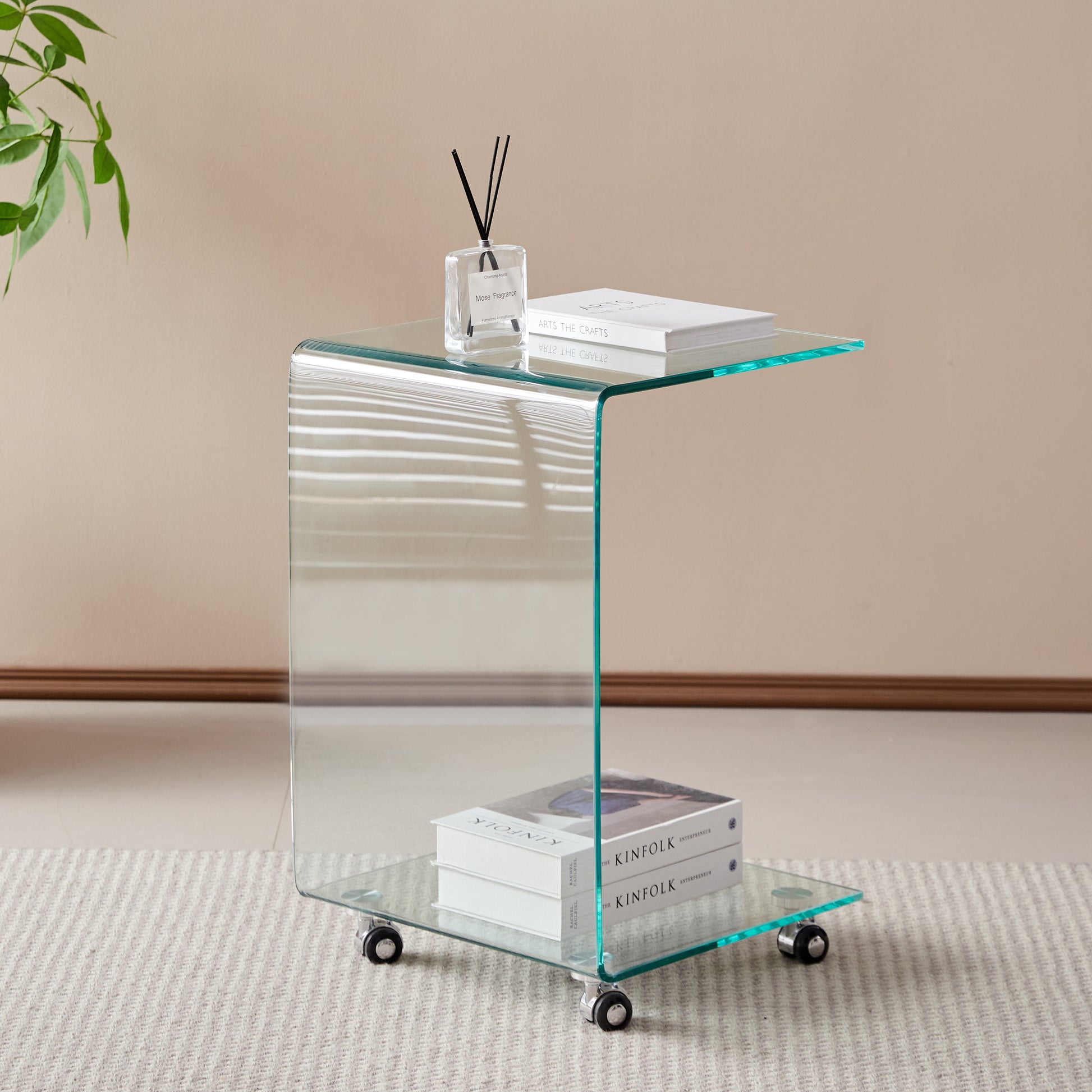 Curved clear glass side table with chrome wheels