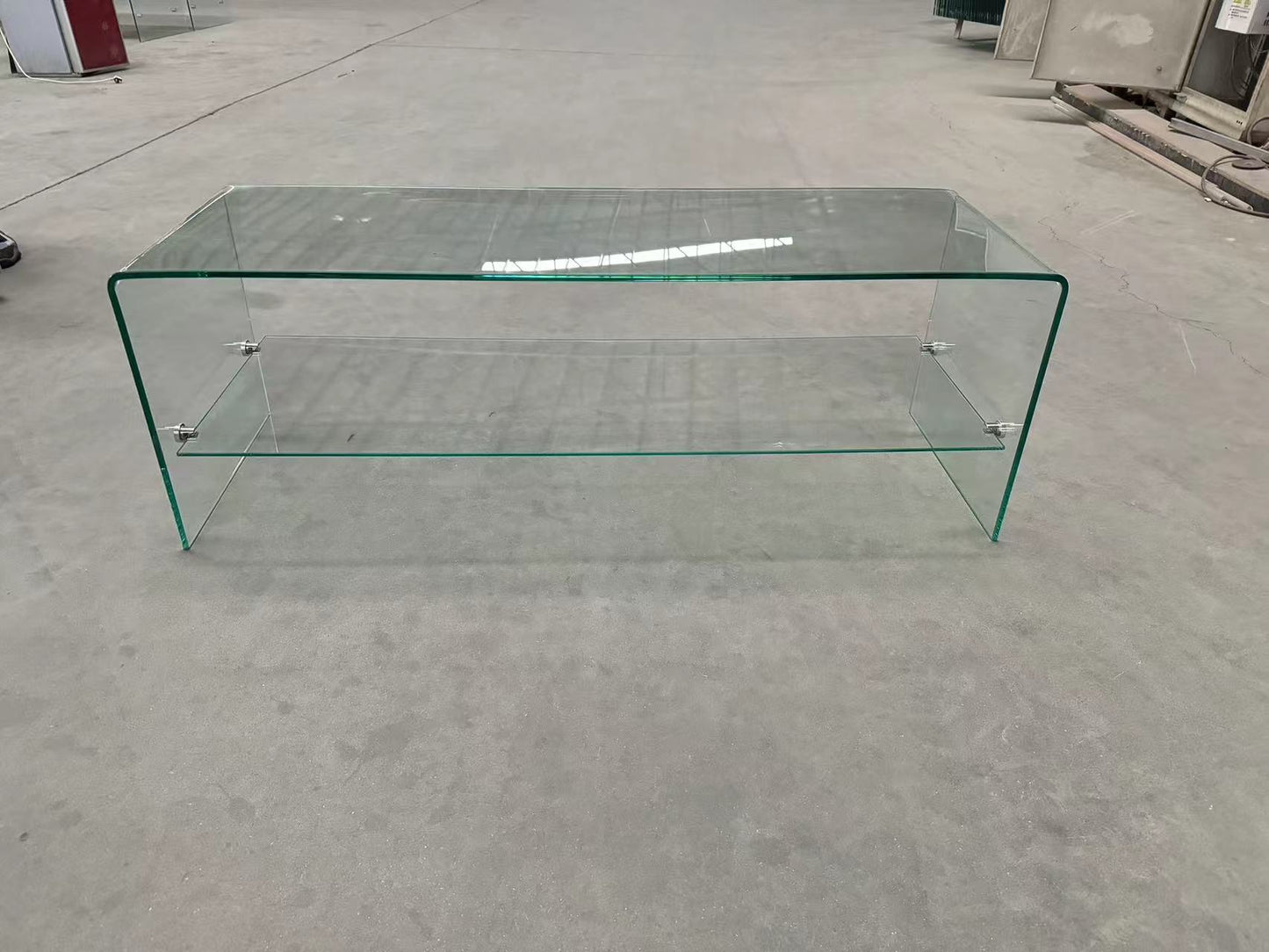 Curved glass coffee table with two shelves and chrome accents