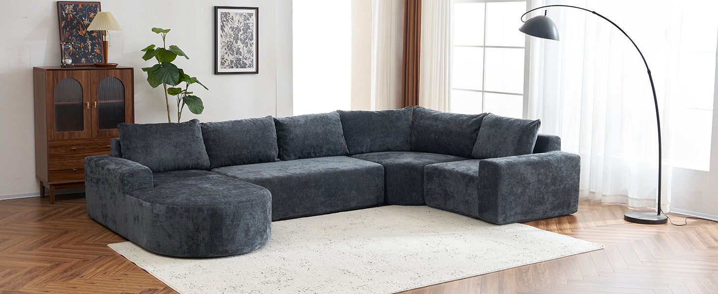 Deep charcoal sectional sofa with plush upholstery and curved chaise