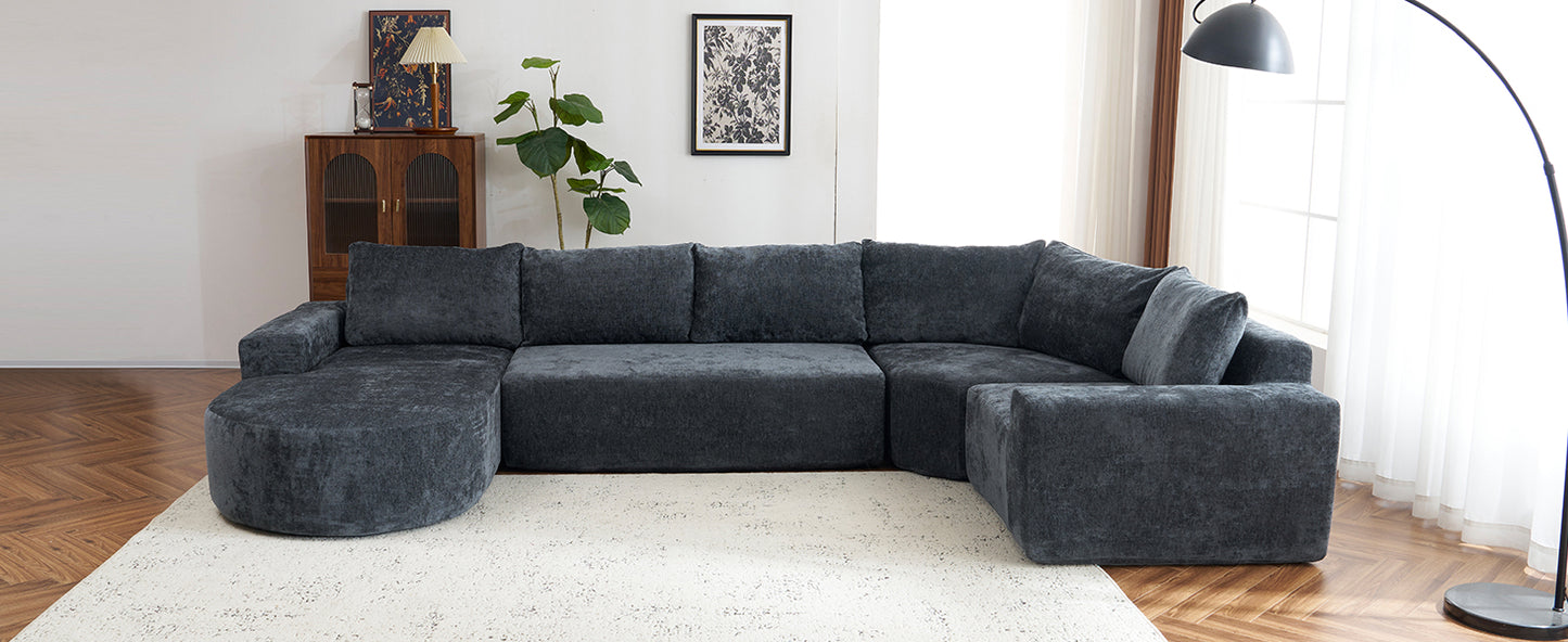 Plush charcoal gray sectional sofa with chaise lounge and ottoman