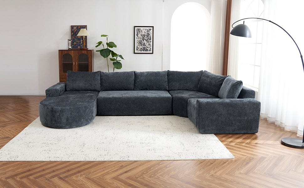 Ushaped charcoal gray fabric sectional sofa with deep cushions and a rounded chaise for comfort