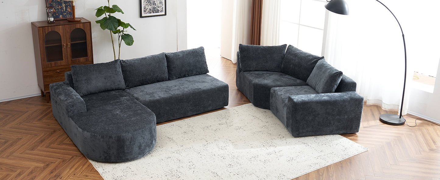 Dark grey sectional sofa with plush cushions and curved armrest