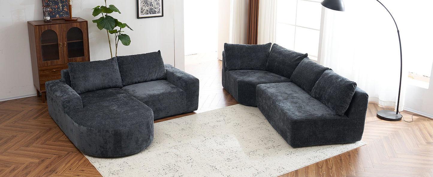 Dark grey plush sectional sofa with rounded chaise