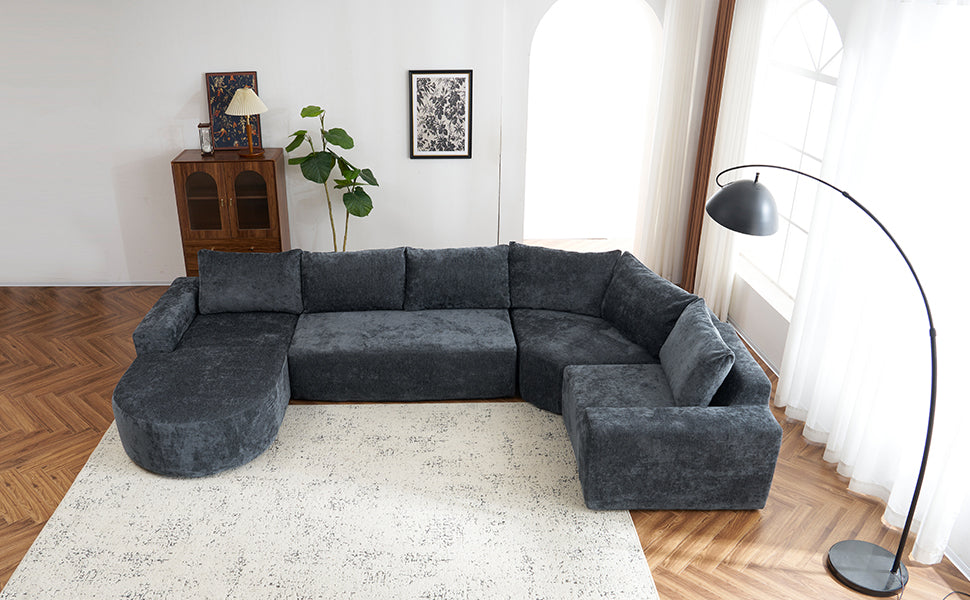 Dark gray sectional sofa with plush fabric and rounded chaise perfect for modern living rooms
