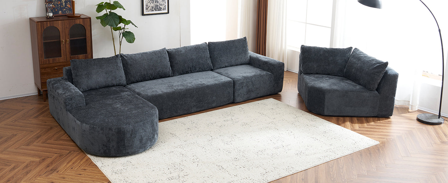 Dark grey plush sectional sofa with chaise lounge and matching armchair