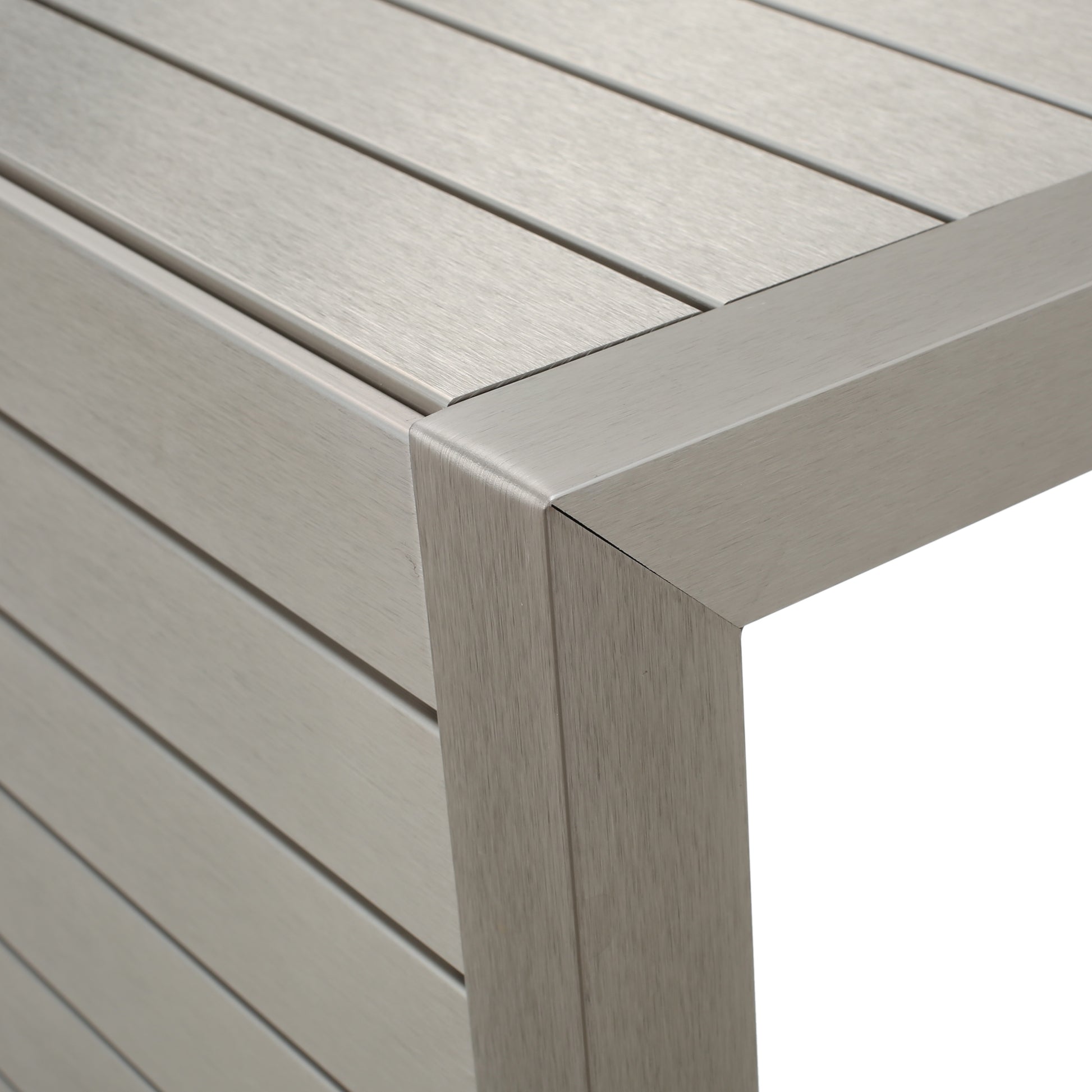Closeup of silver brushed aluminum outdoor table corner