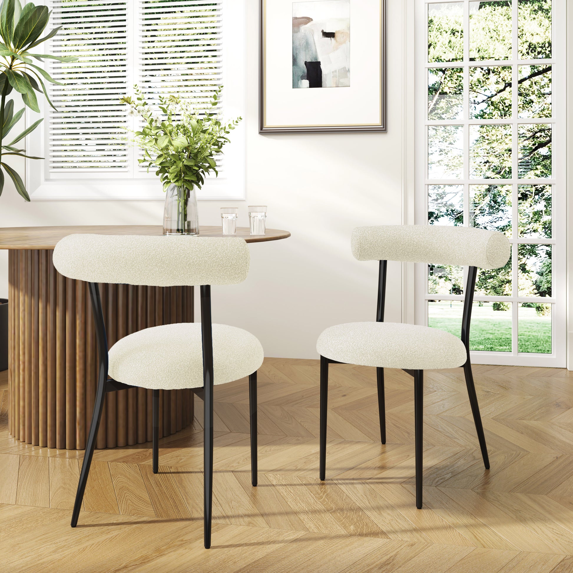 Cream boucle dining chairs with black metal legs
