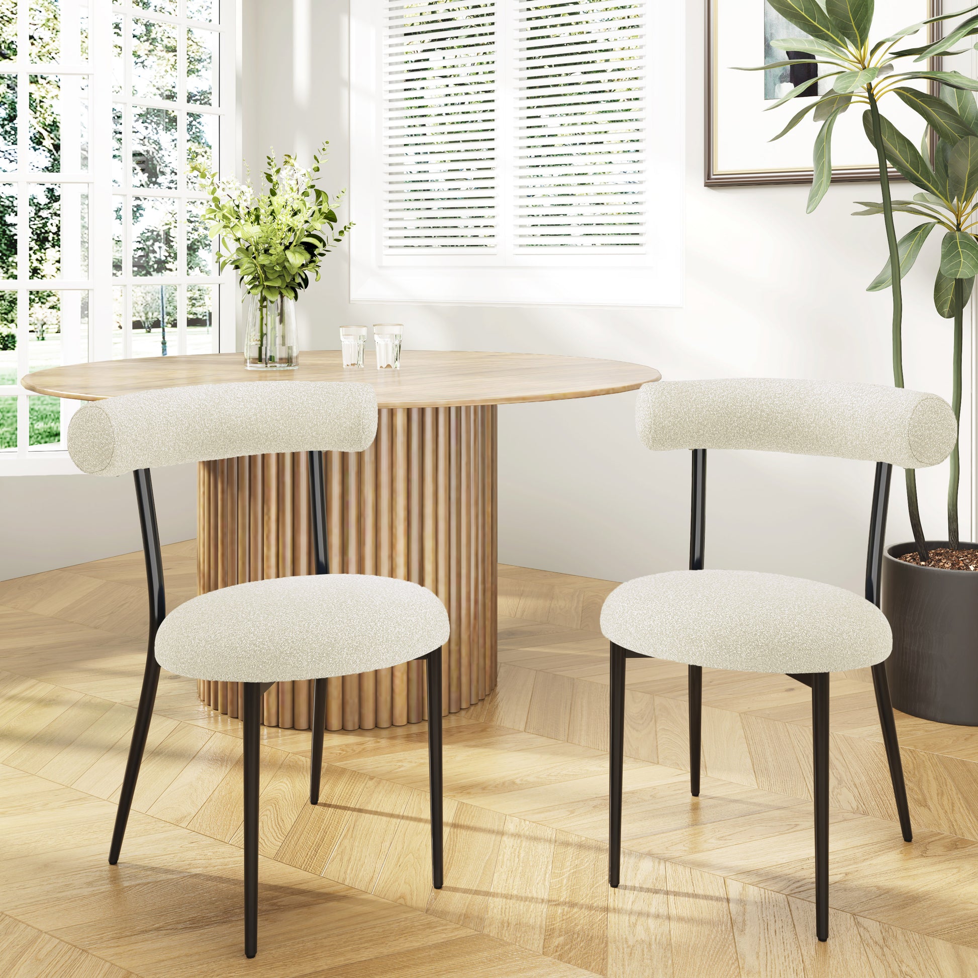 Cream boucle dining chair with black metal legs