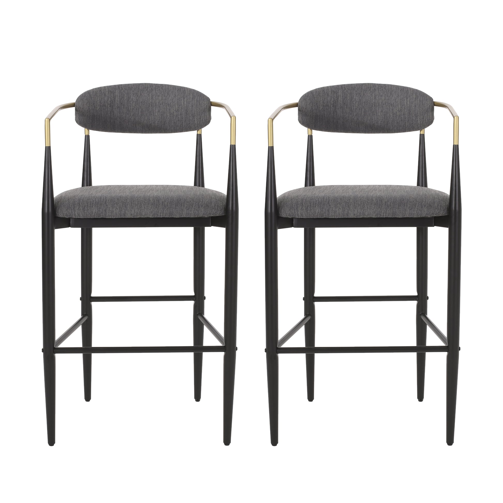 Two grey upholstered bar stools with black tapered legs and gold accents