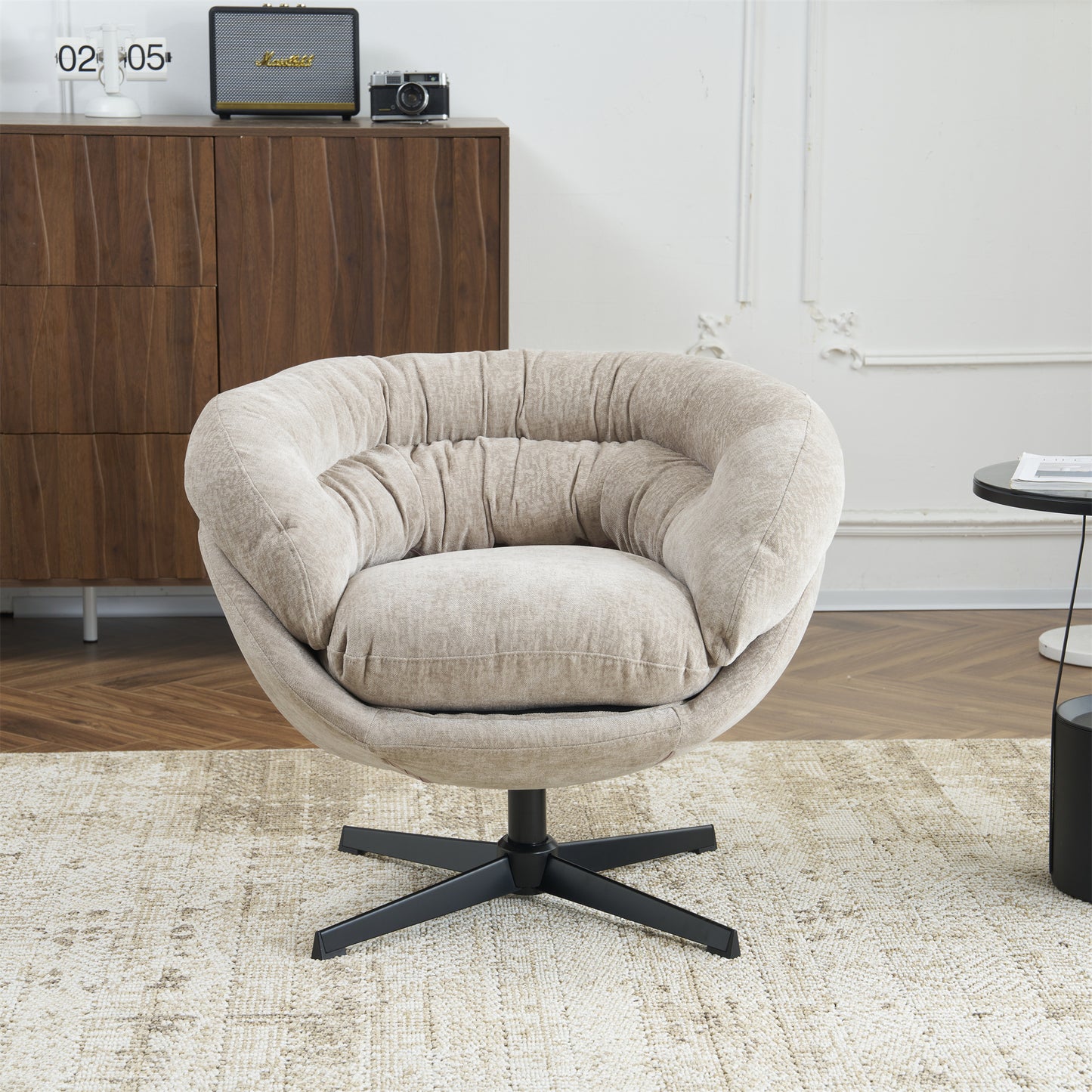 Plush beige swivel accent chair with gathered fabric and a black star base