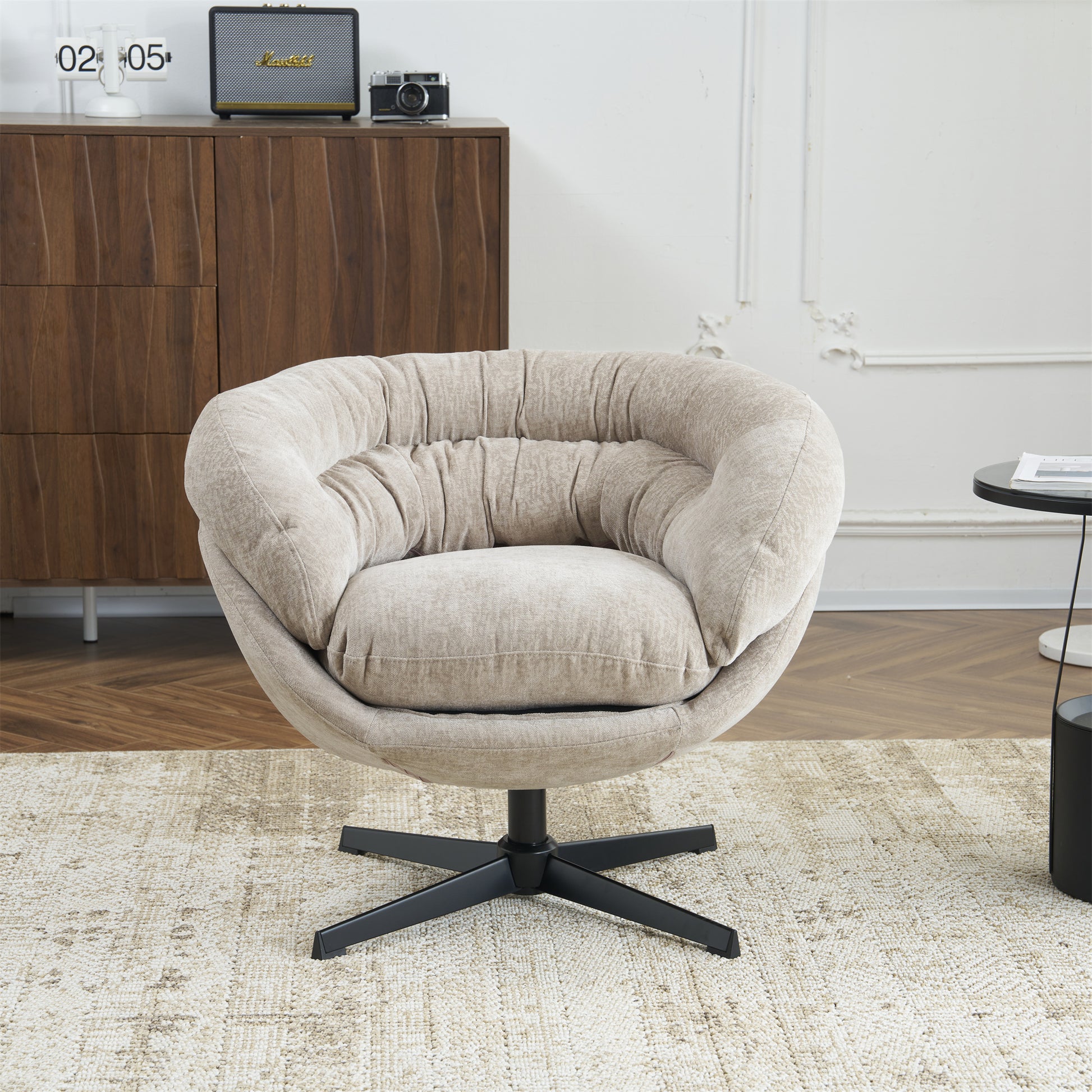 Plush beige swivel accent chair with gathered fabric and a black star base