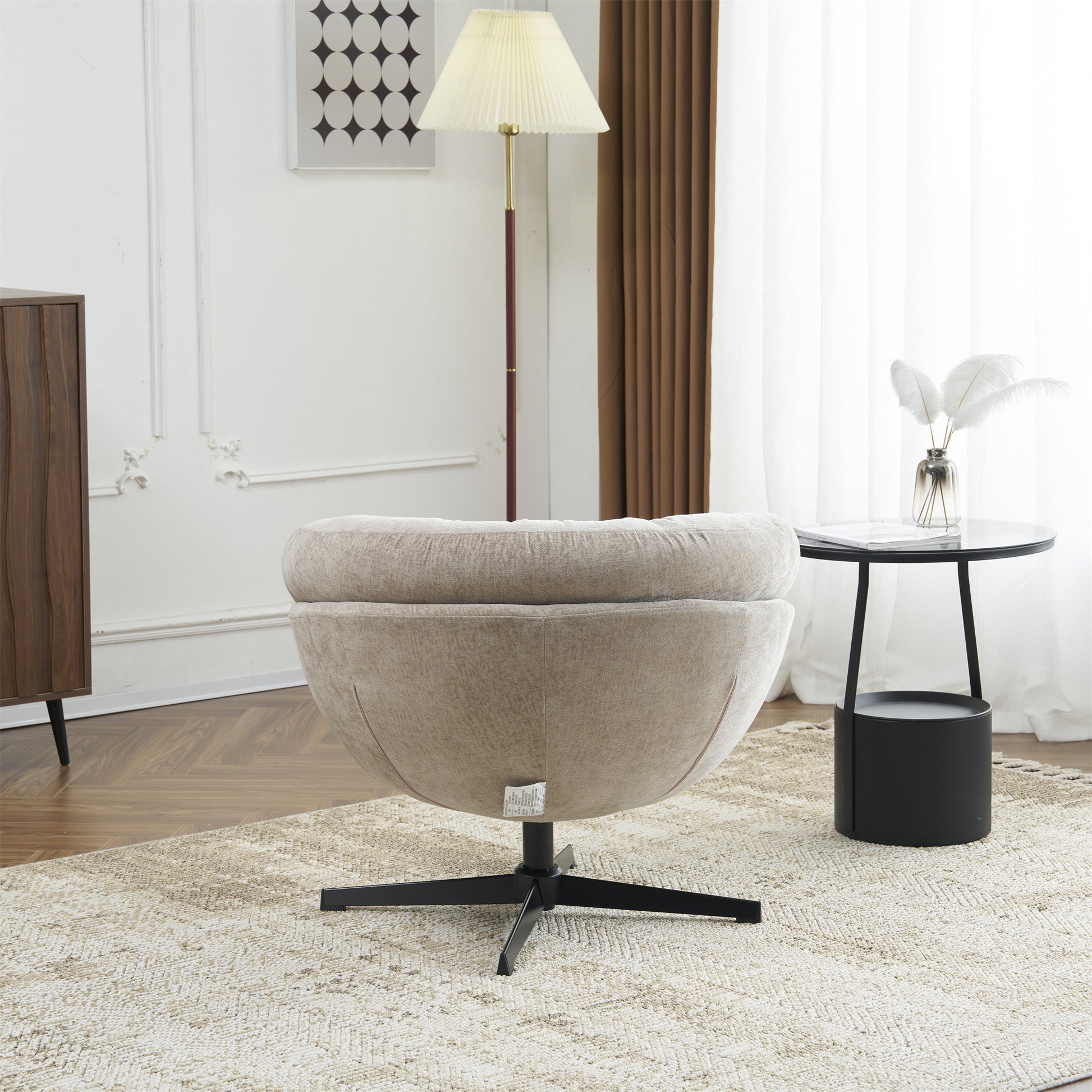 Beige upholstered accent chair with a swivel base and plush cushioning