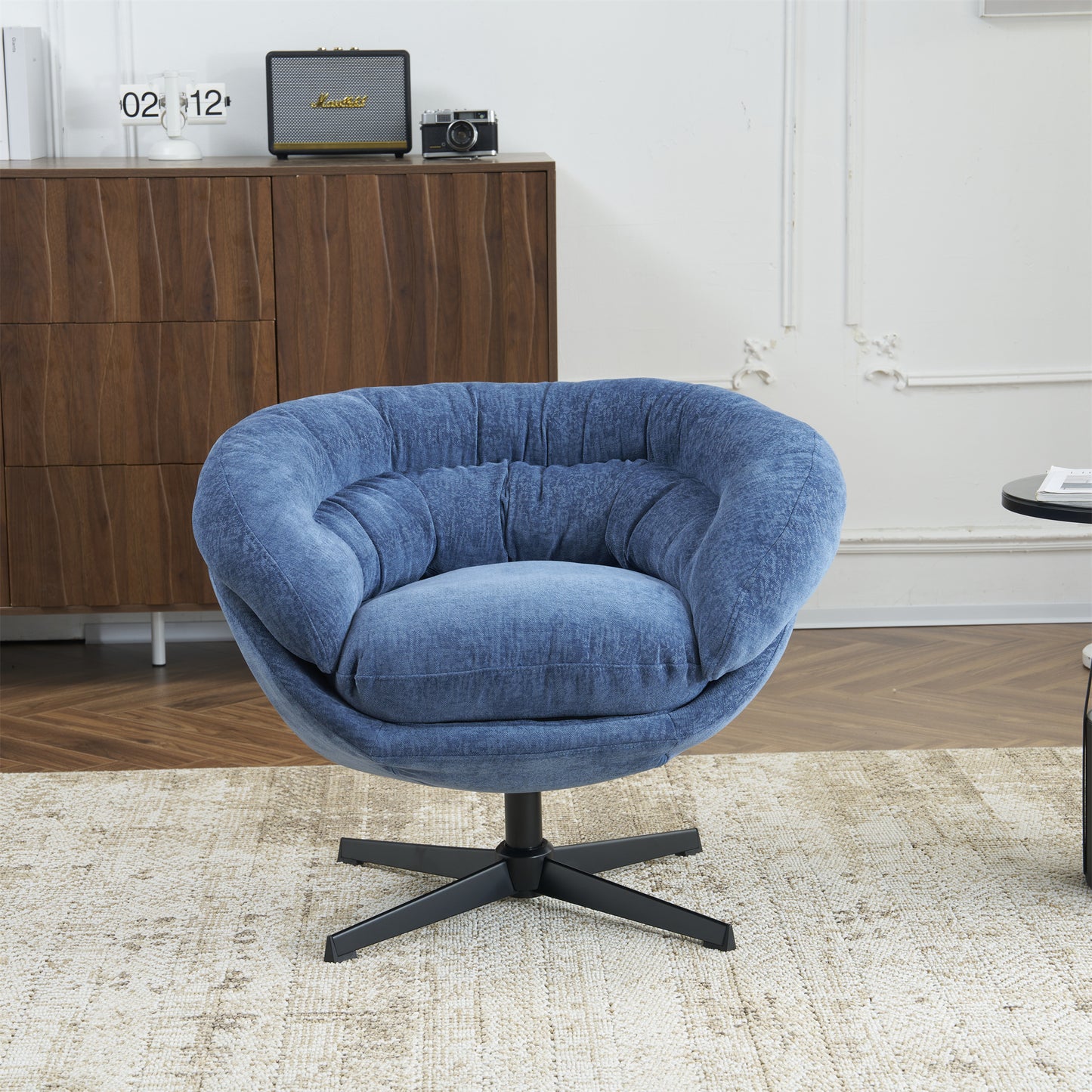 Plush blue swivel accent chair with deep tufting and black metal base