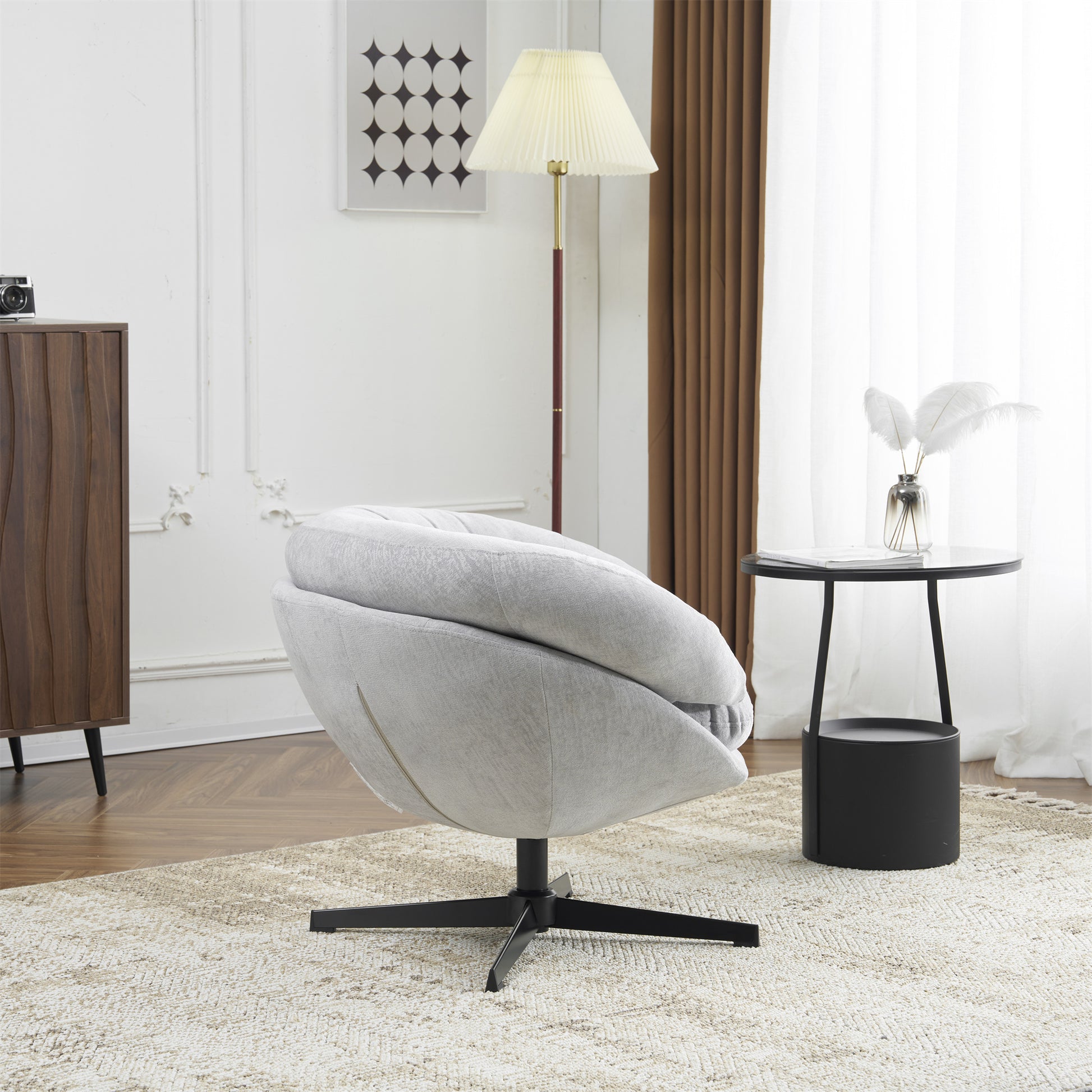 Light grey upholstered swivel accent chair with black base