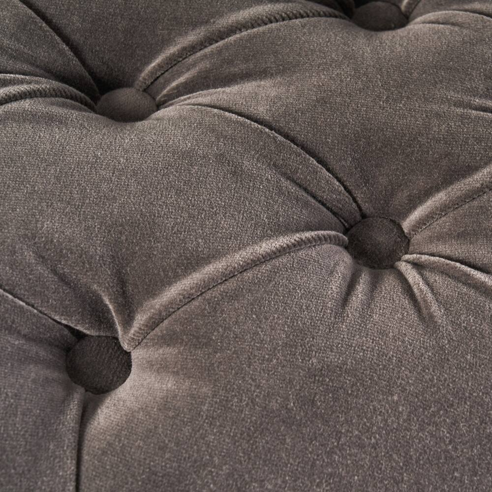 Closeup of charcoal grey velvet fabric with deep button tufting for sofas