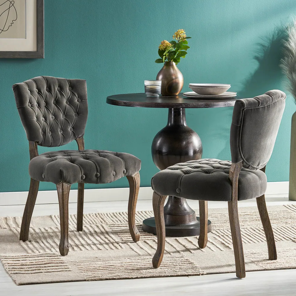 Tufted grey velvet dining chair with carved wooden legs