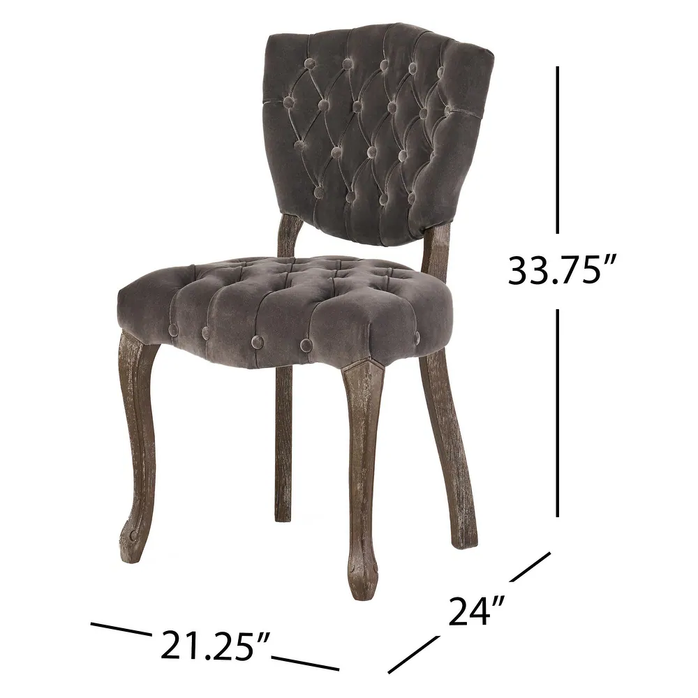 Dark gray velvet accent chair with button tufting and ornate wooden legs