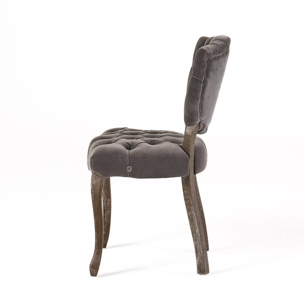 Grey velvet tufted accent chair with dark wood legs