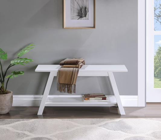 Modern white entryway bench with lower shelf and folded blankets