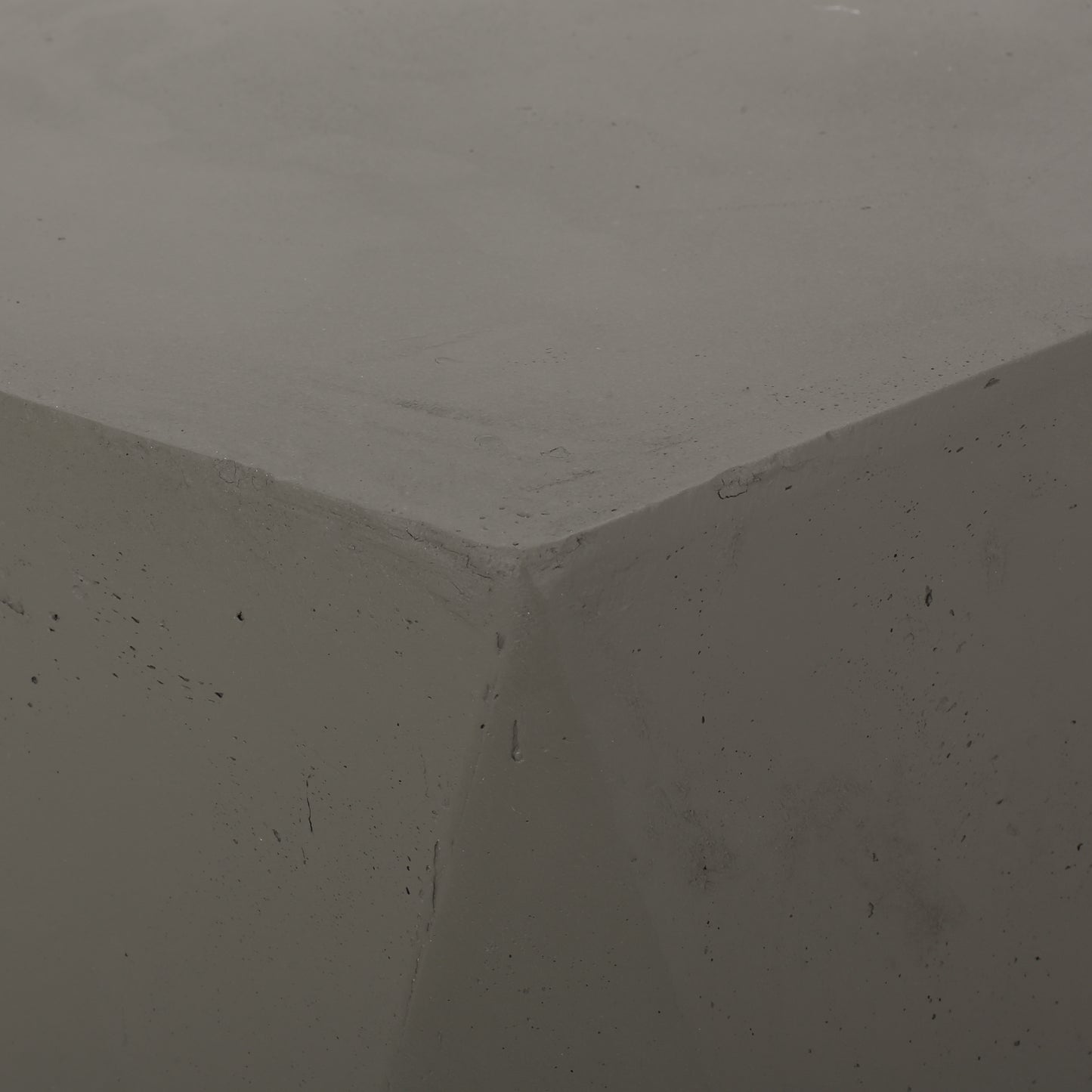 Closeup of textured grey concrete cube corner