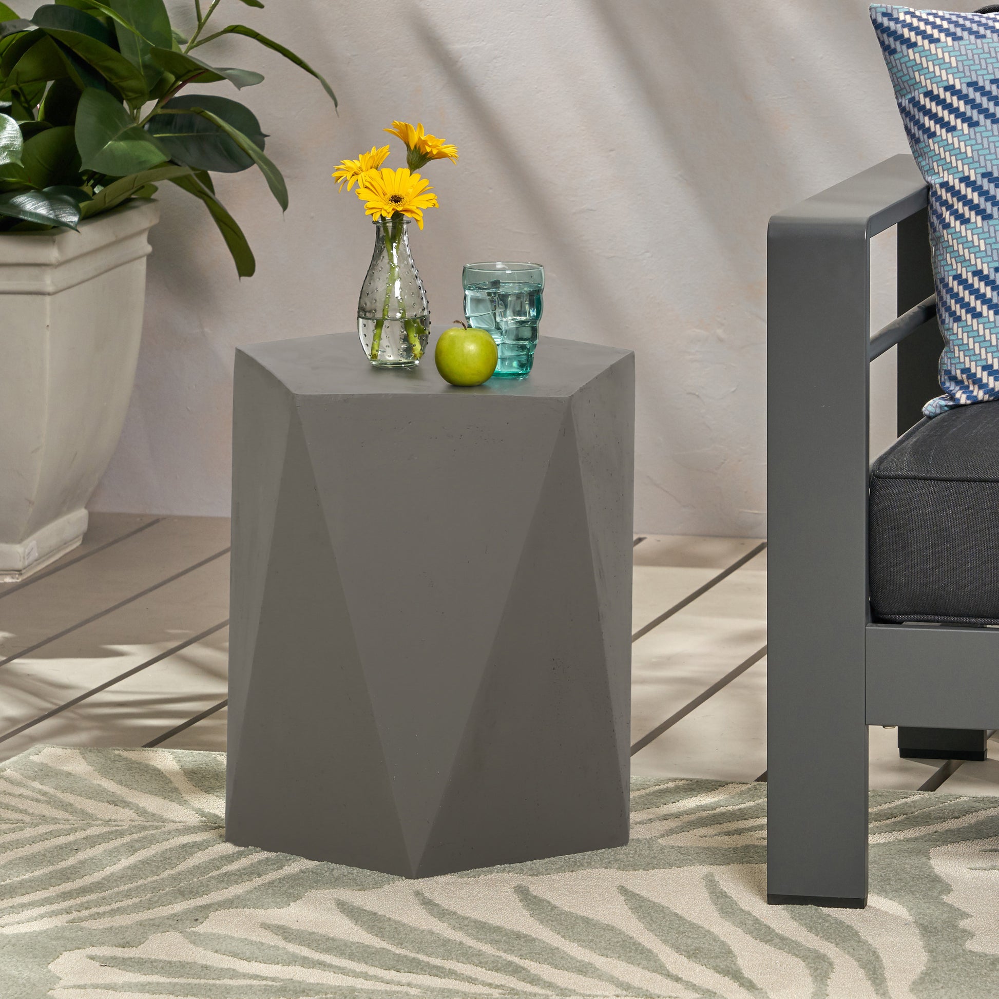 Geometric grey concrete side table with faceted design