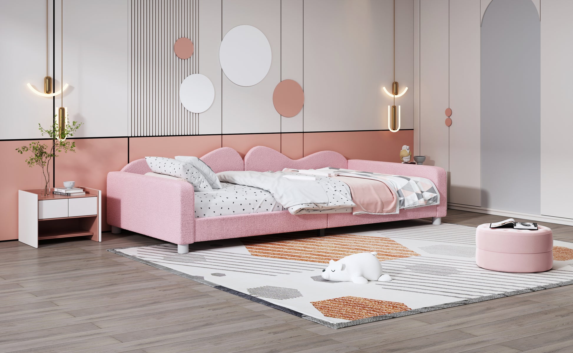 Pink upholstered twin daybed with wavy headboard and alphabet print bedding