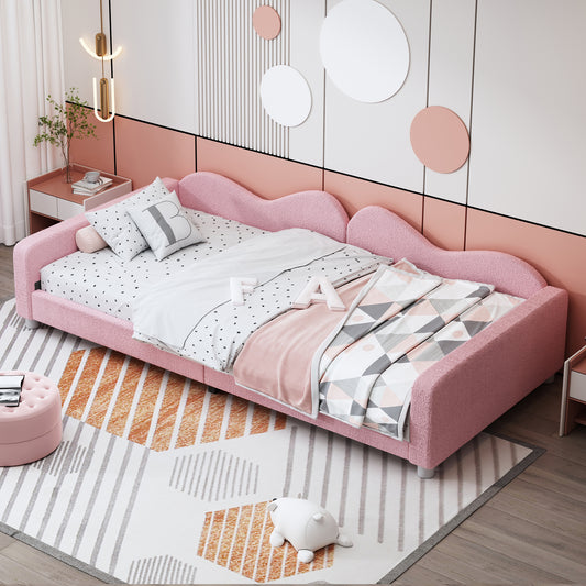 Pink fuzzy twin bed with waveshaped headboard and fun bedding