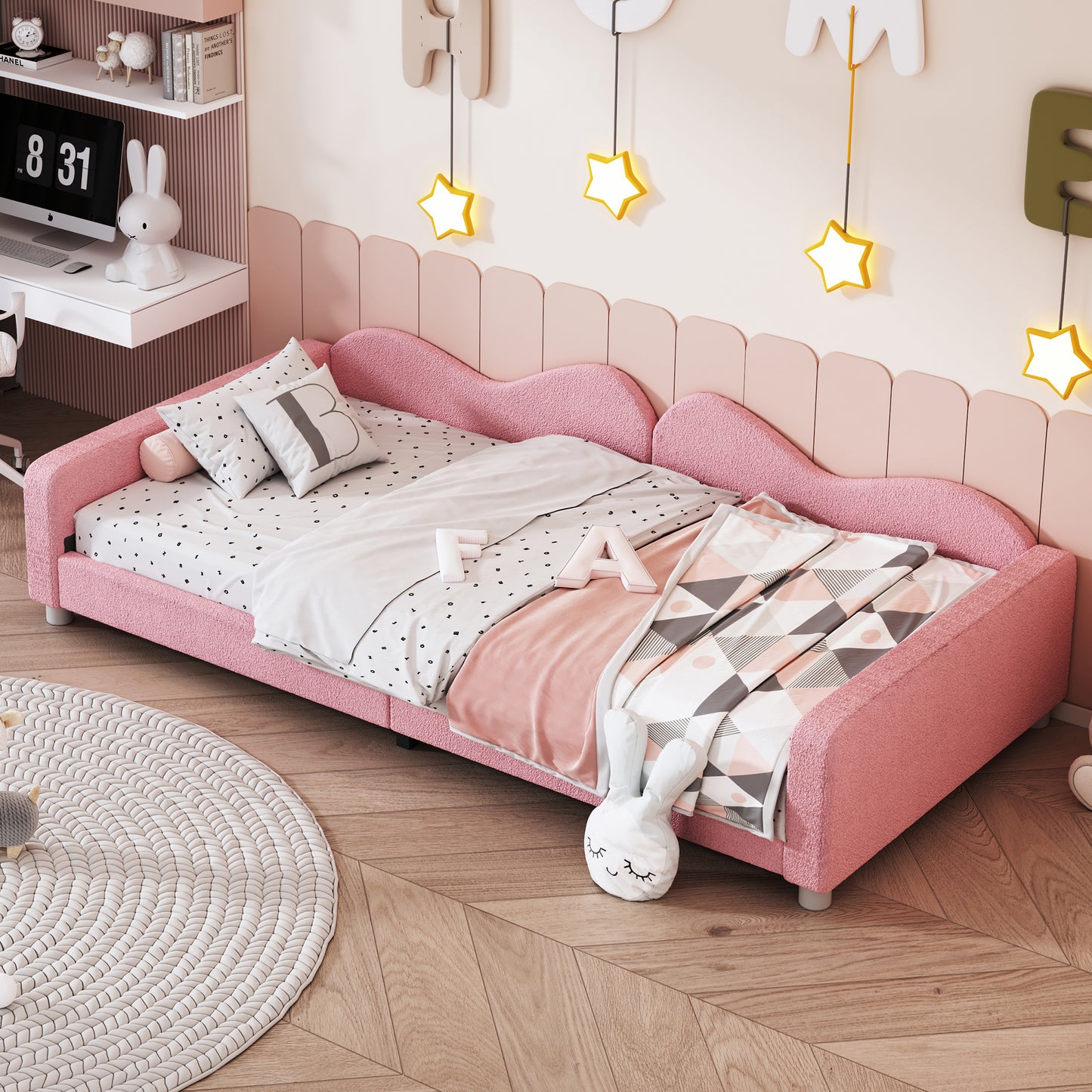 Pink boucle fabric toddler bed with heartshaped headboard and playful bedding