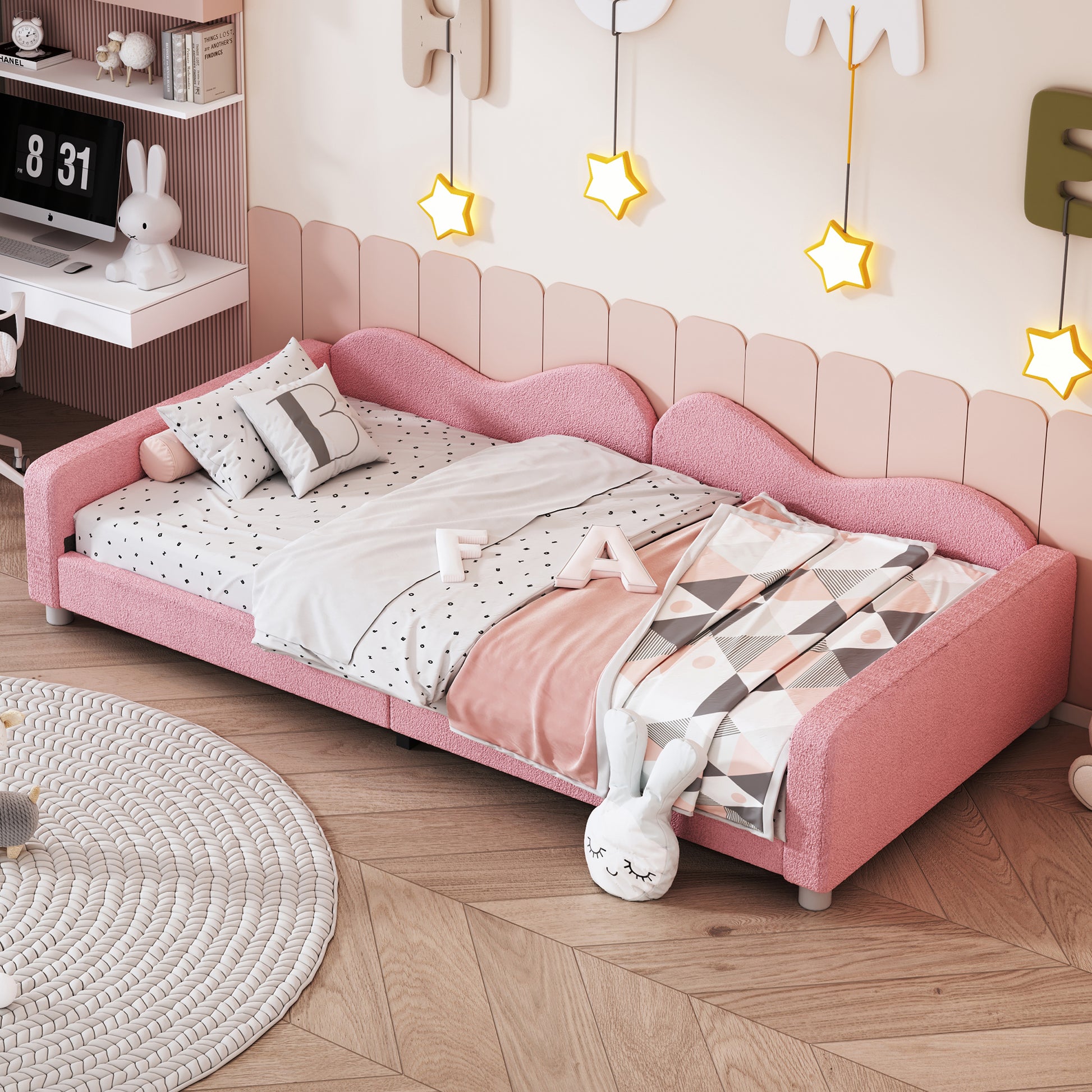 Pink boucle fabric toddler bed with heartshaped headboard and playful bedding