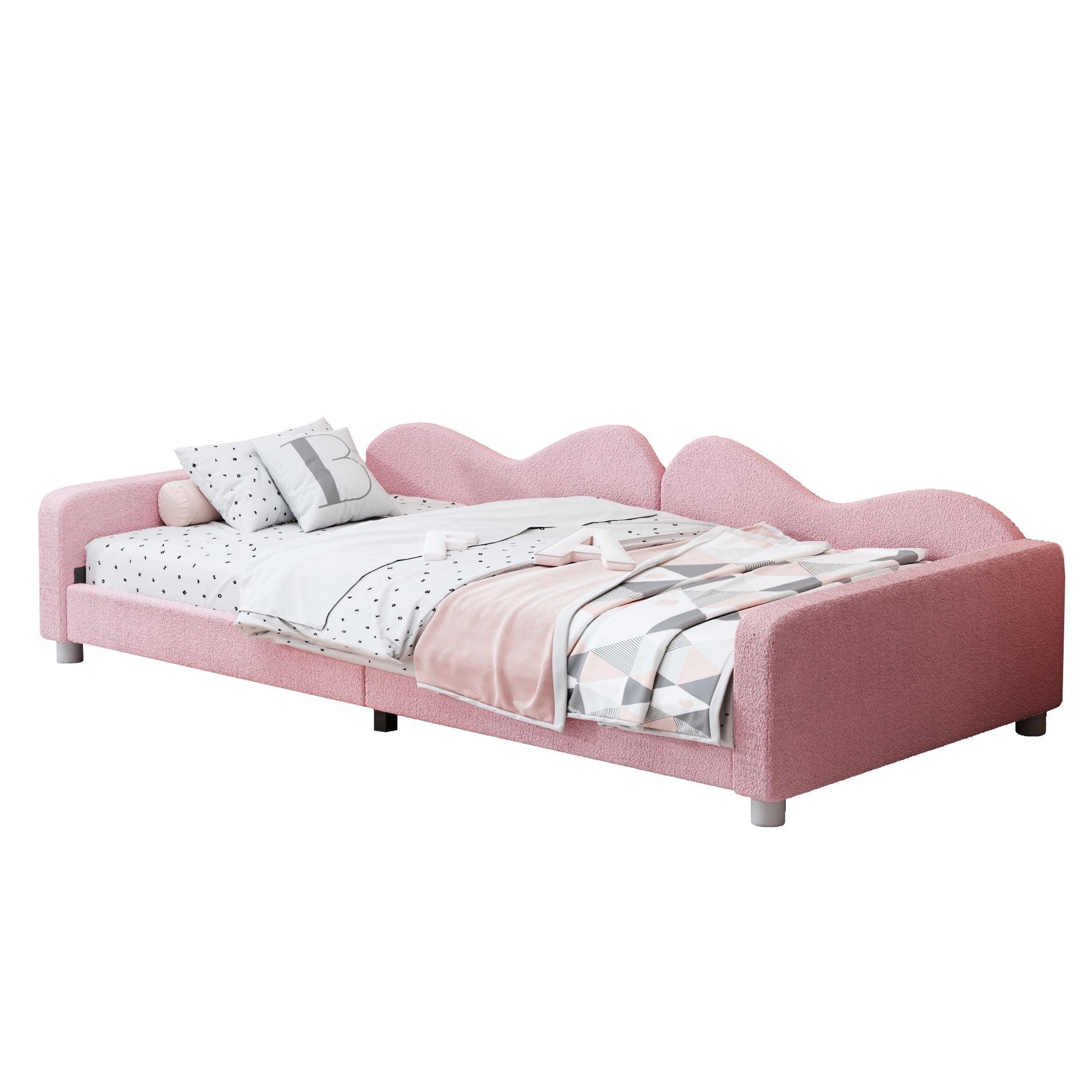 Pink boucle toddler bed with playful wavy headboard and patterned bedding