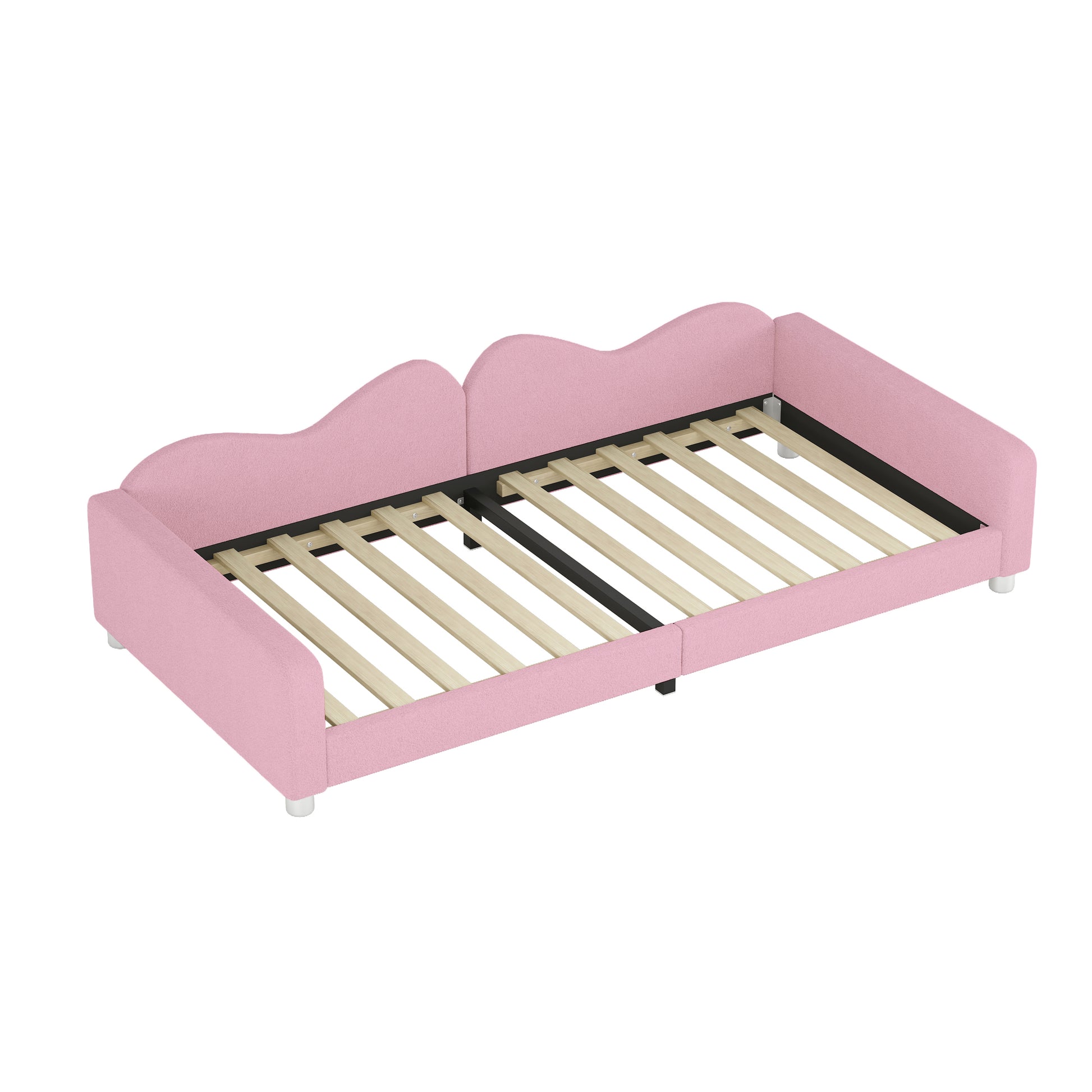 Pink upholstered twin daybed with scalloped headboard and wooden slats for mattress support