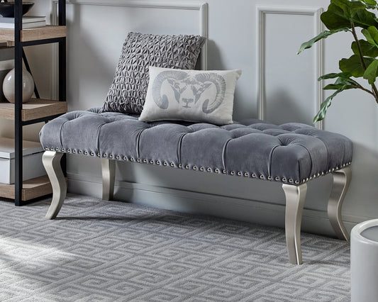 Tufted grey velvet bench with silver nailhead trim and ornate legs