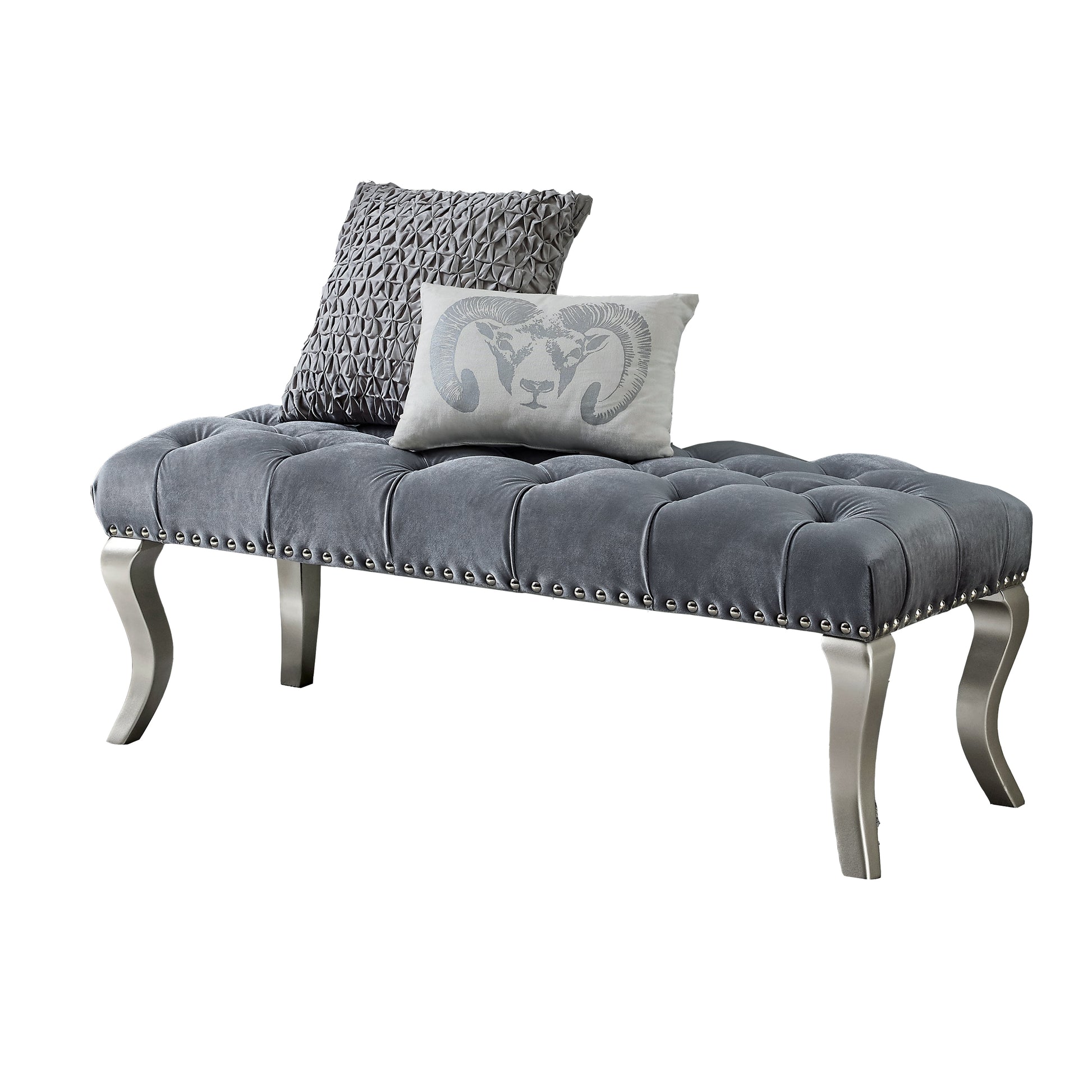 Grey velvet tufted bench with silver nailhead trim and decorative pillows