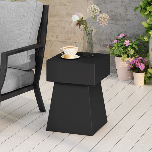 Modern black geometric end table with coffee cup