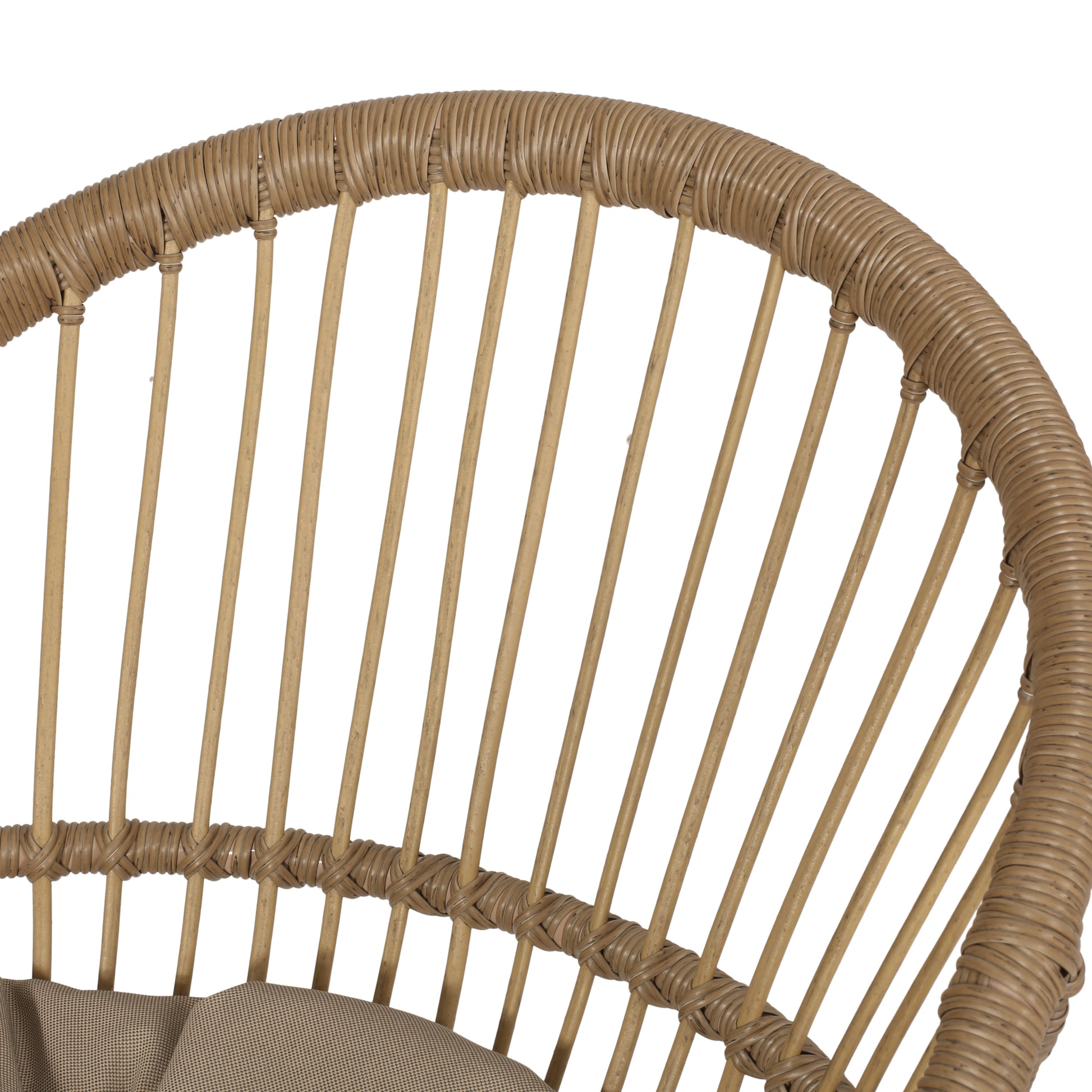 Close up of tan rattan chair back with woven detail and wooden spindles