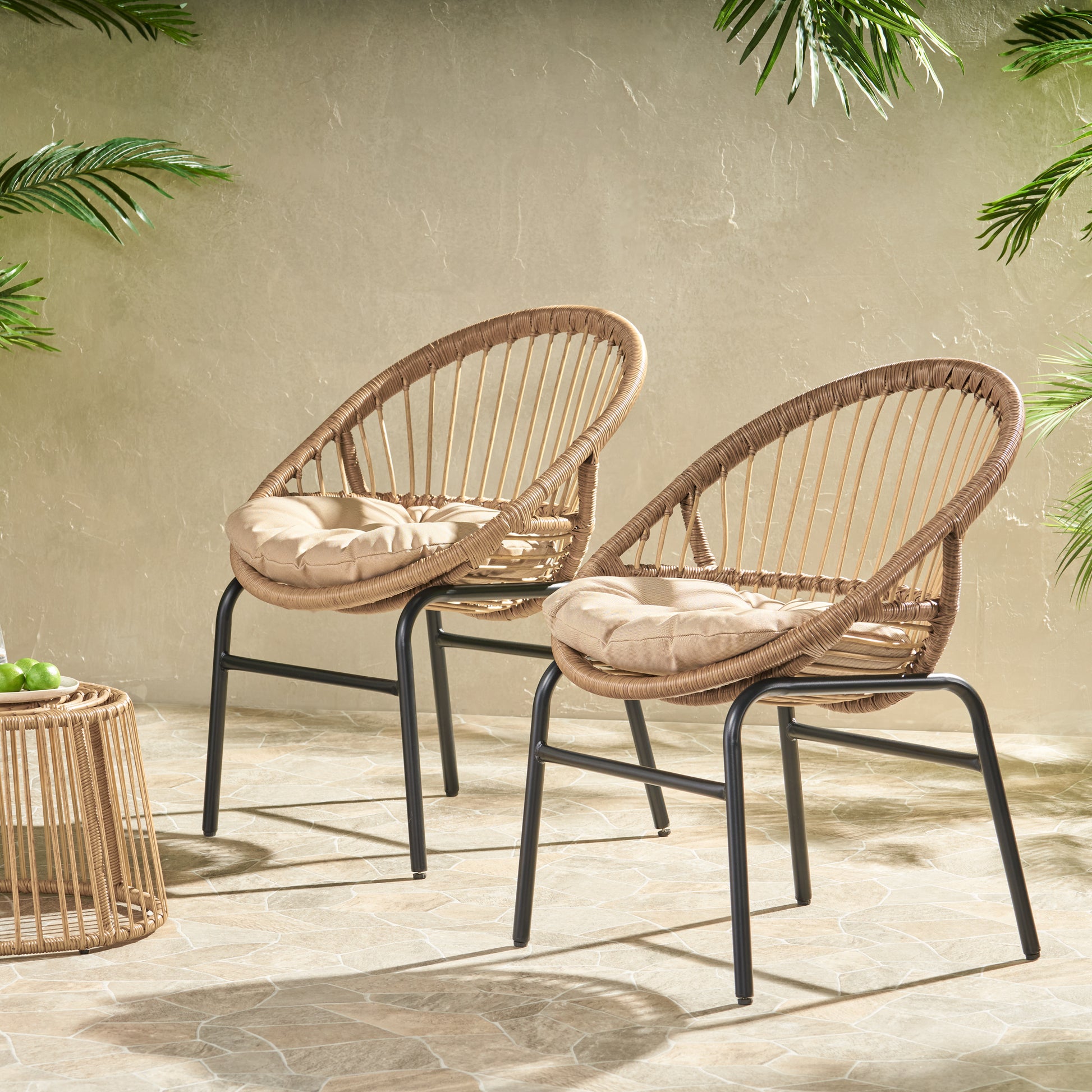 Woven rattan armchair with tan cushion