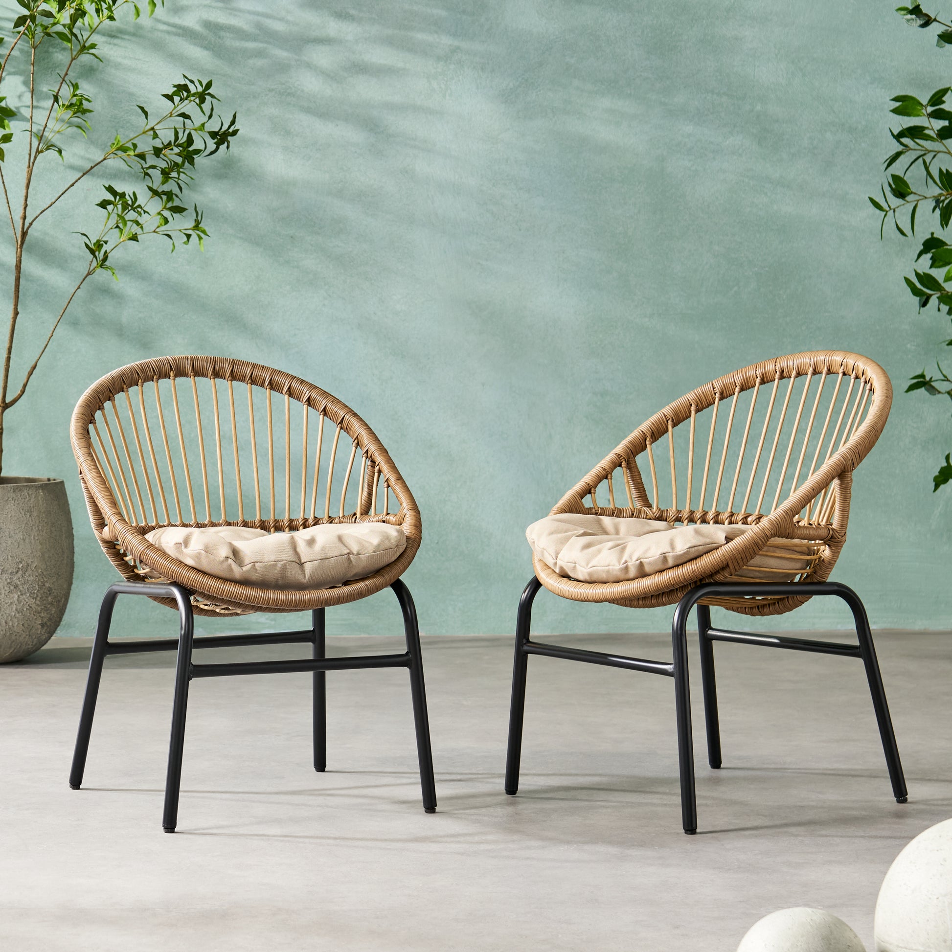 Wicker accent chair with beige cushion and black metal legs
