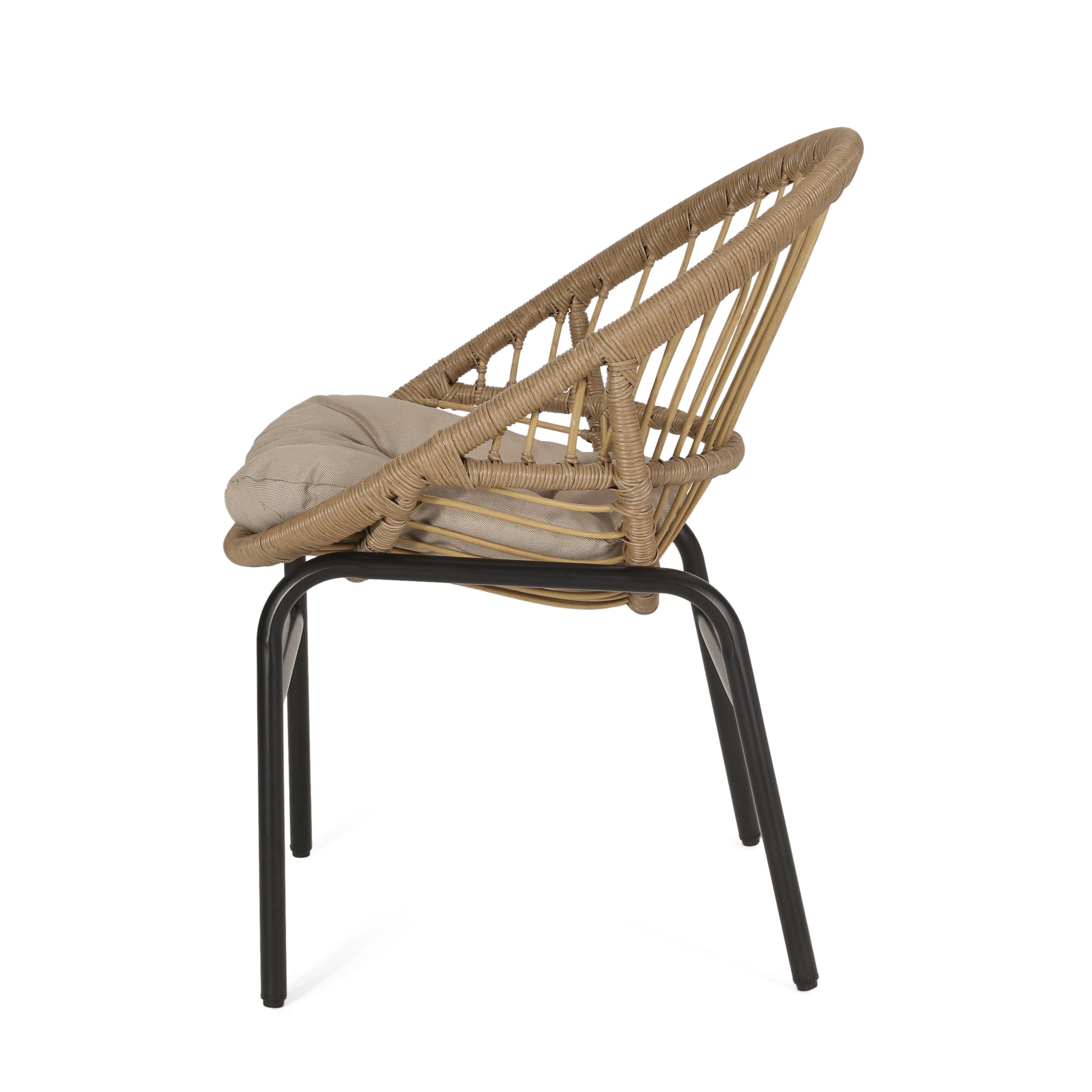 Natural rattan accent chair with beige cushion and black metal legs