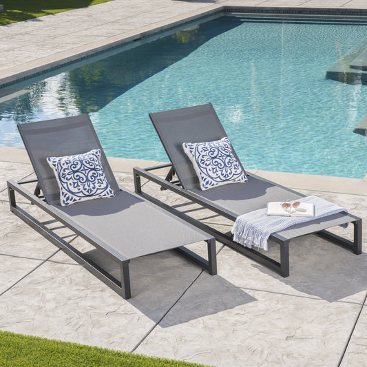 Gray mesh chaise lounge chair with blue ornate pillow
