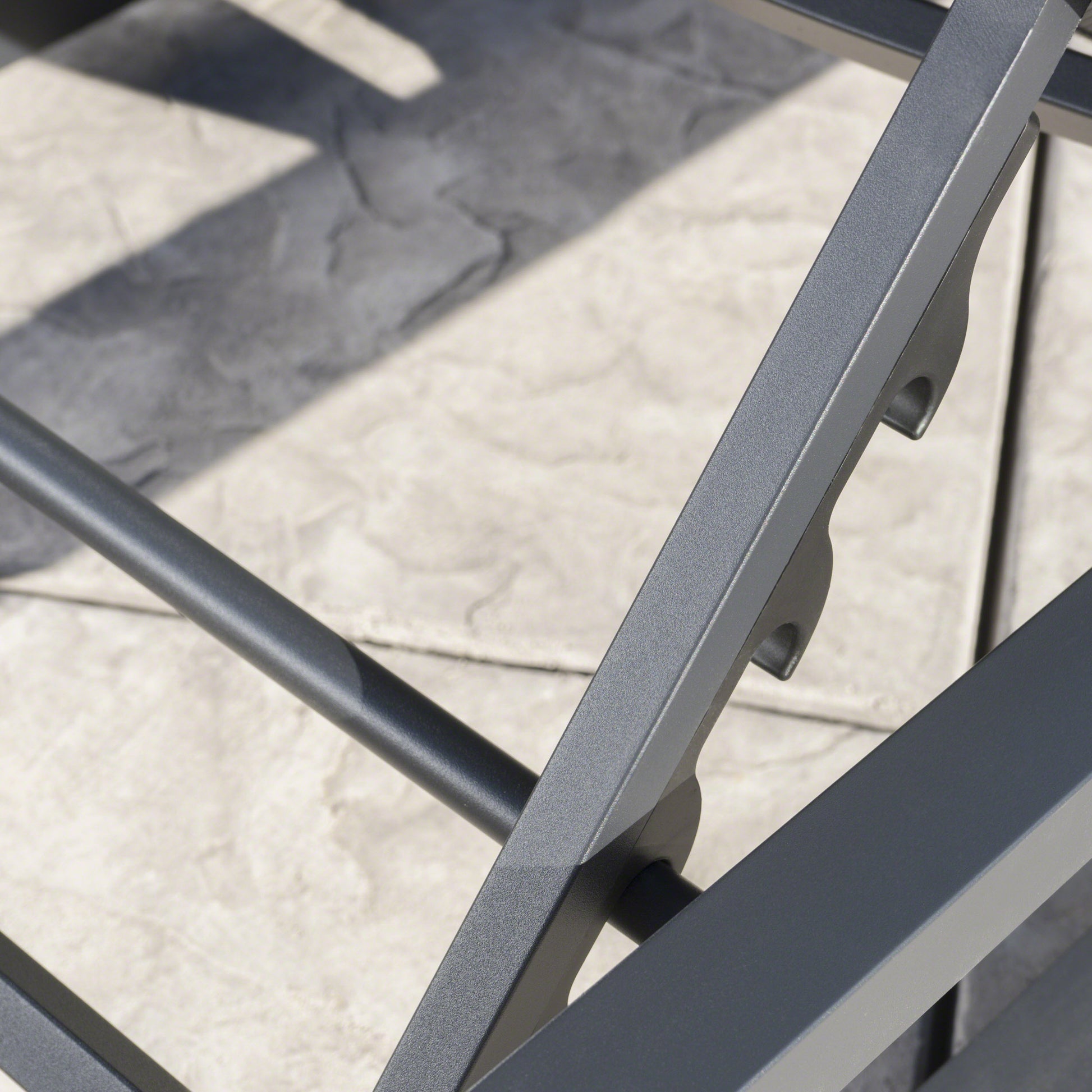 Closeup of dark grey metal frame with textured finish