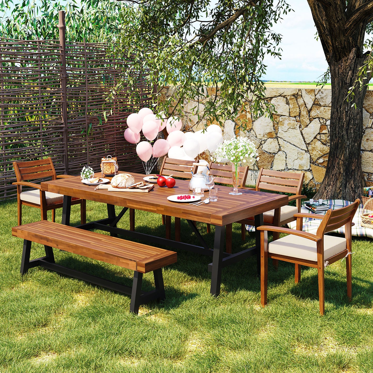 Wooden dining table set with bench and chairs on lush green grass