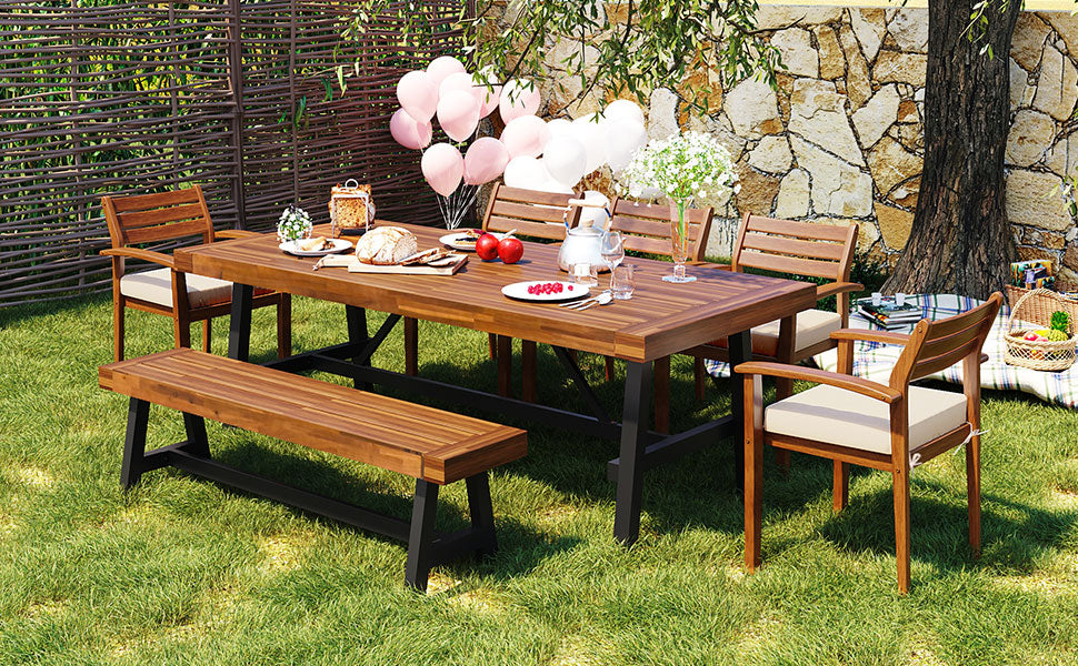 Acacia wood outdoor dining table and chairs set with beige cushions