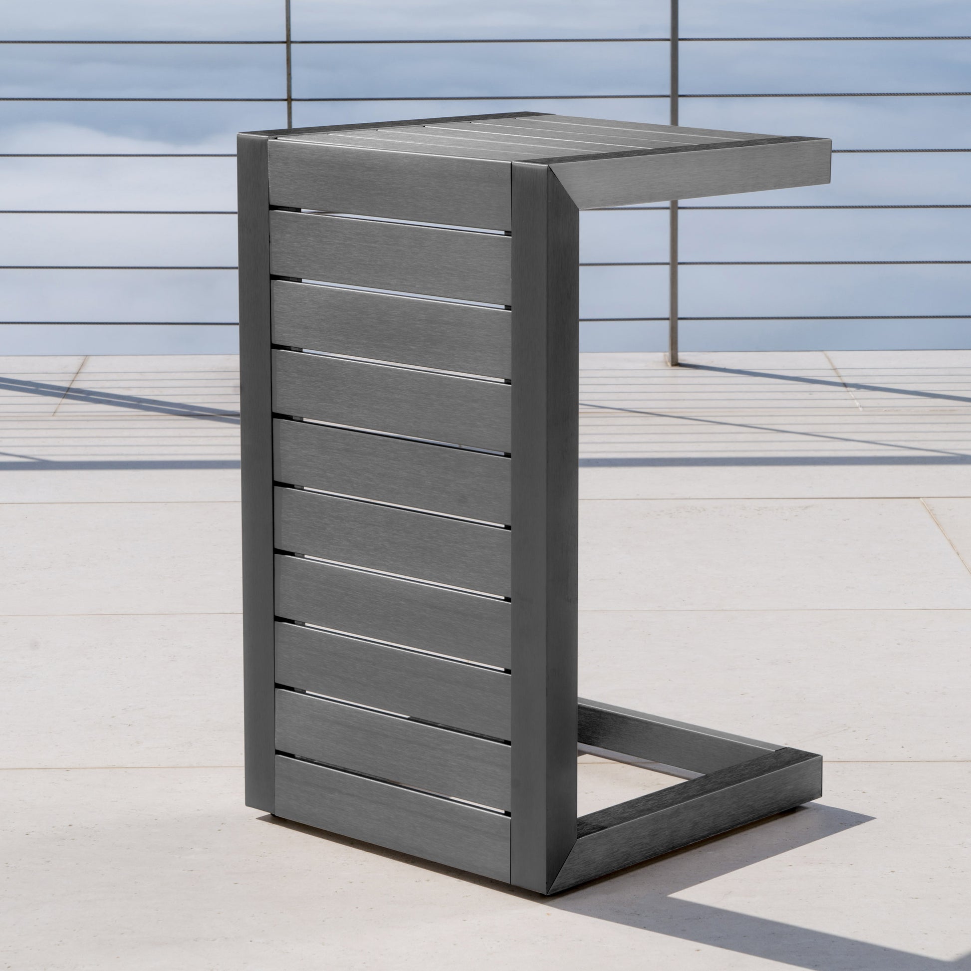 Modern grey slatted ctable for outdoor use on patio decking