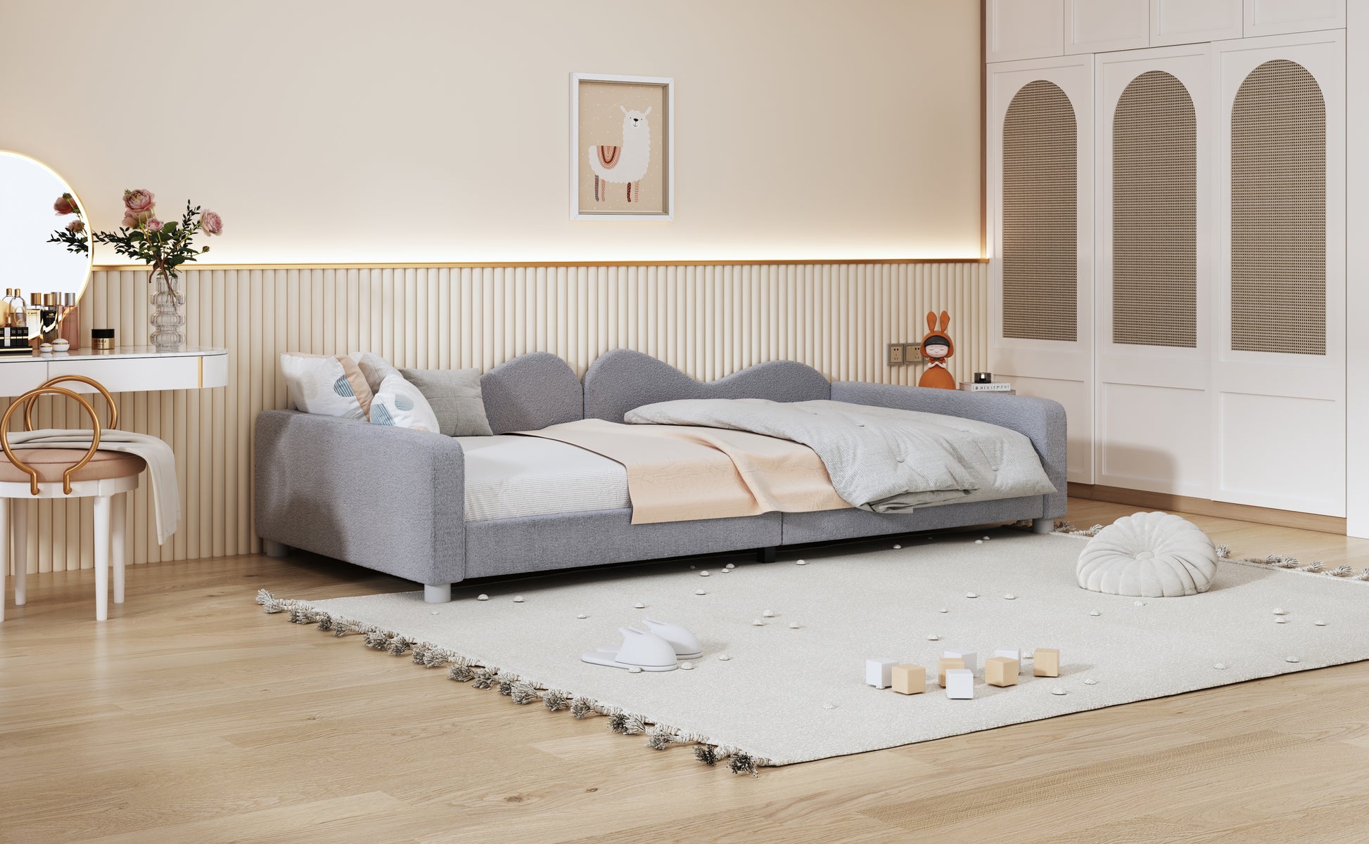 Grey fabric kids daybed with playful scalloped edges and patterned pillows