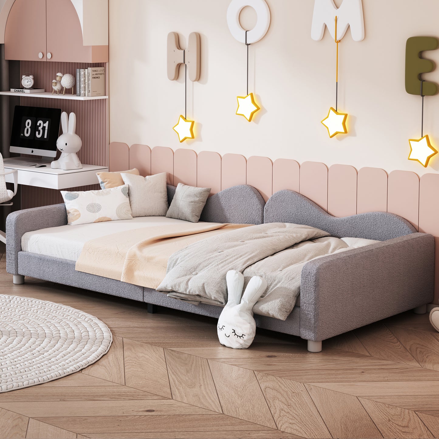 Gray upholstered daybed with soft blankets and pillows perfect for a childs room