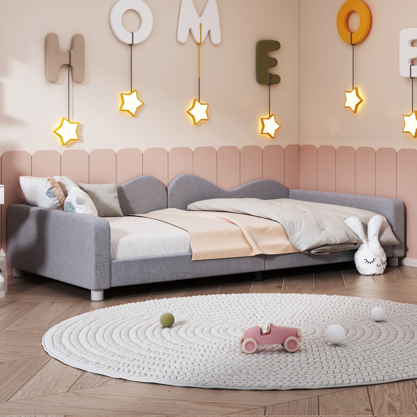 Gray textured twin bed with playful star lights and pillows