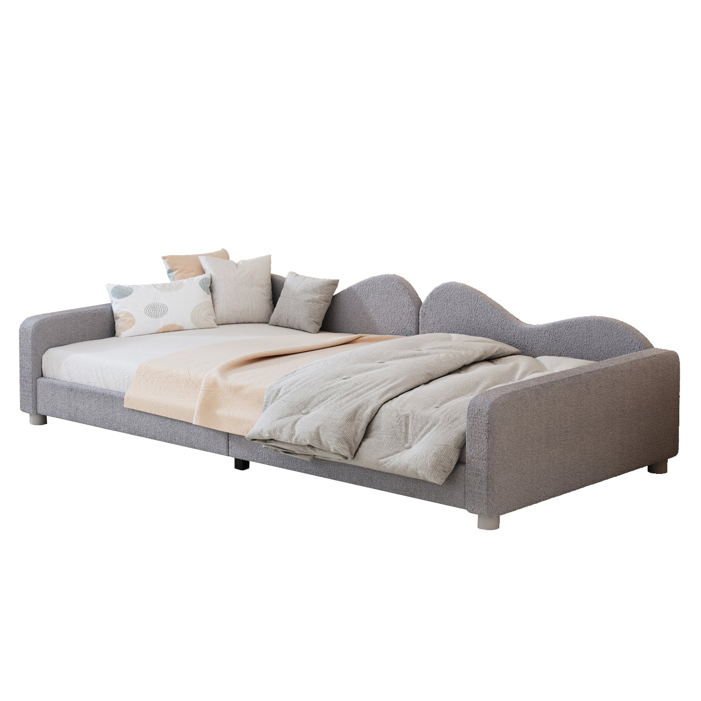 Grey fabric daybed with waveshaped headboard and decorative pillows