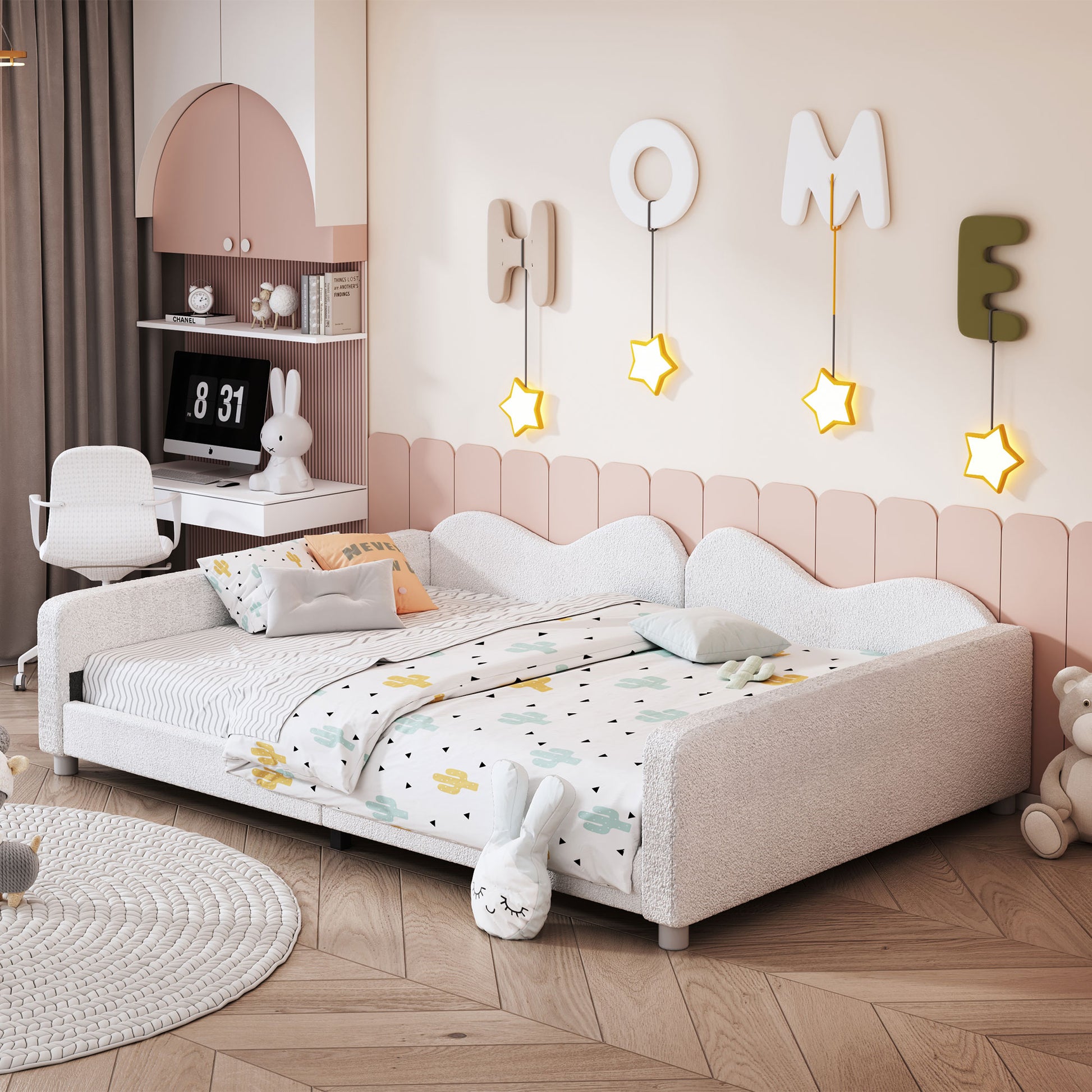 White upholstered daybed with cactus print bedding and pastel accents